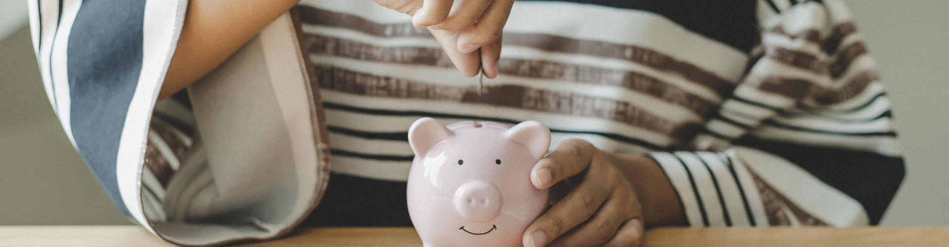 A person holding a piggy bank.