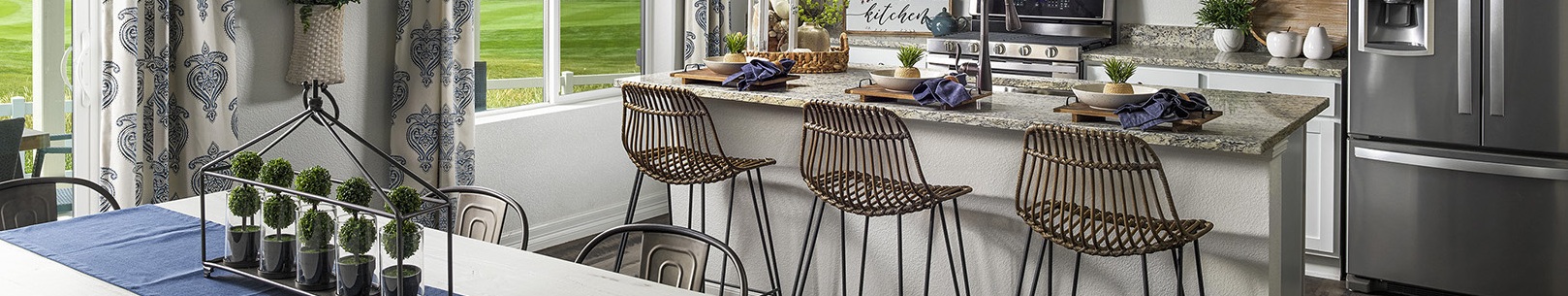 A kitchen with a table and chairs.