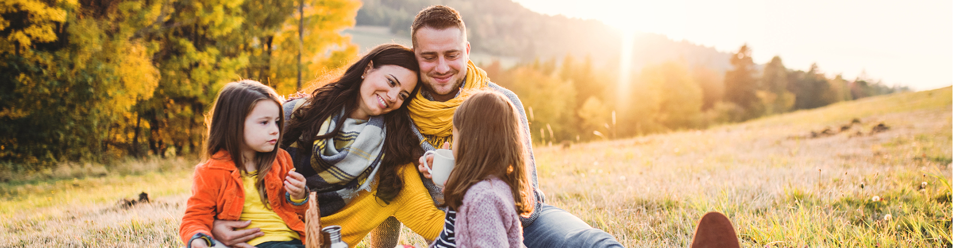 A group of people sitting together outside.