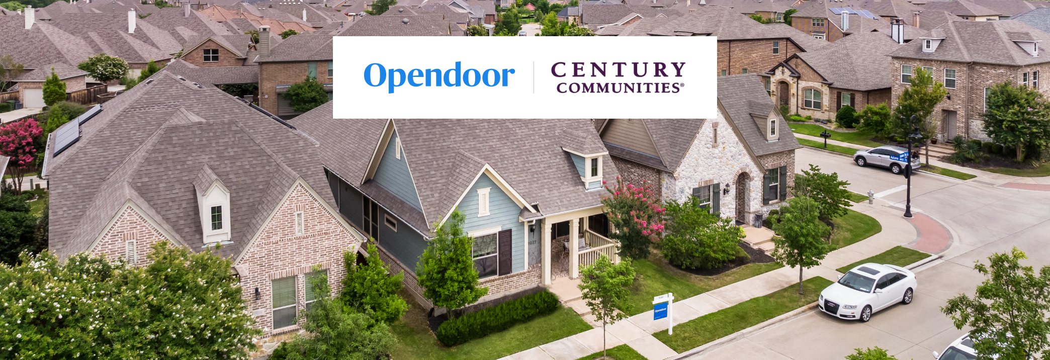 A street with houses and cars.