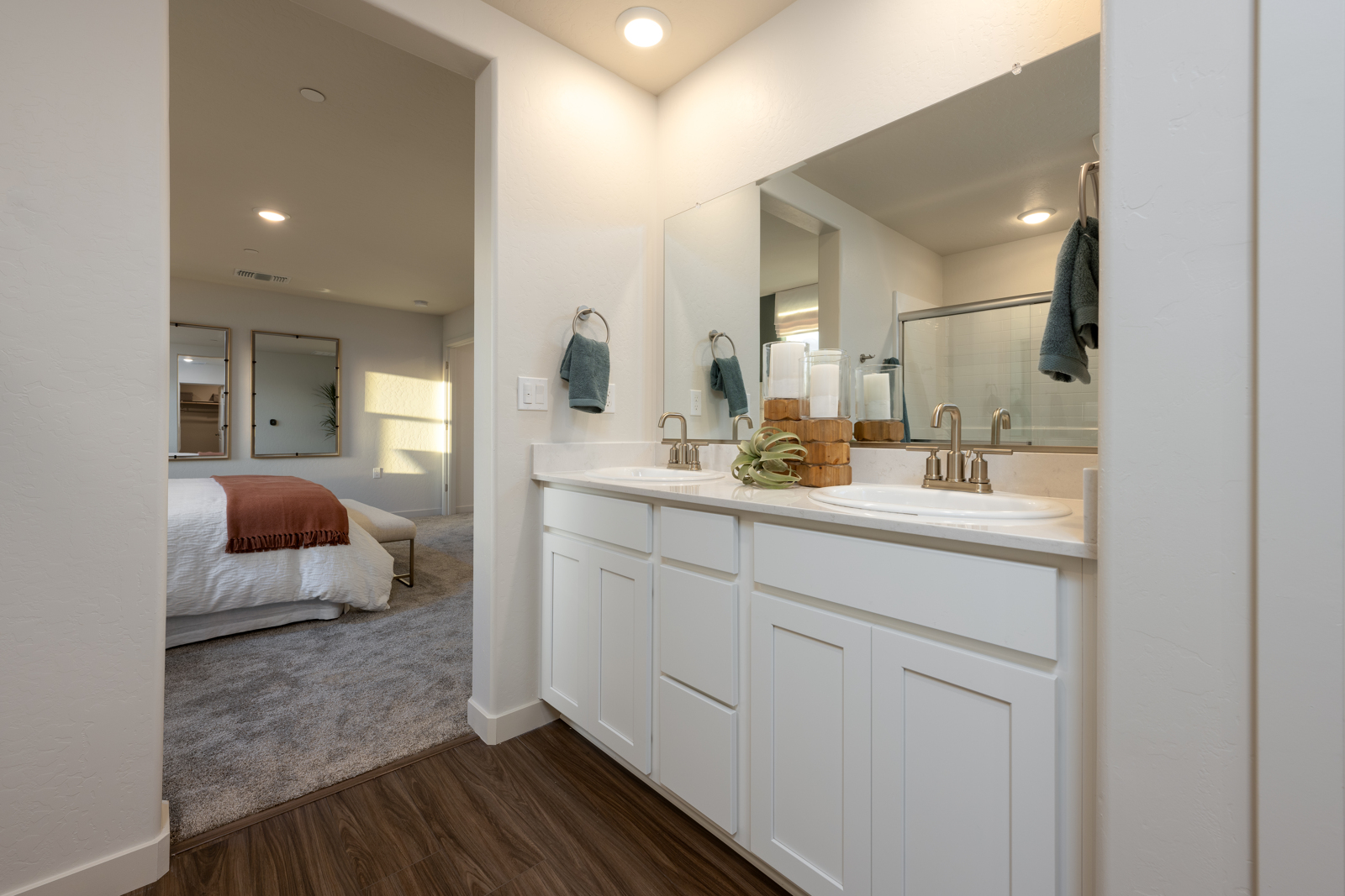 A bathroom with a bed and sink.
