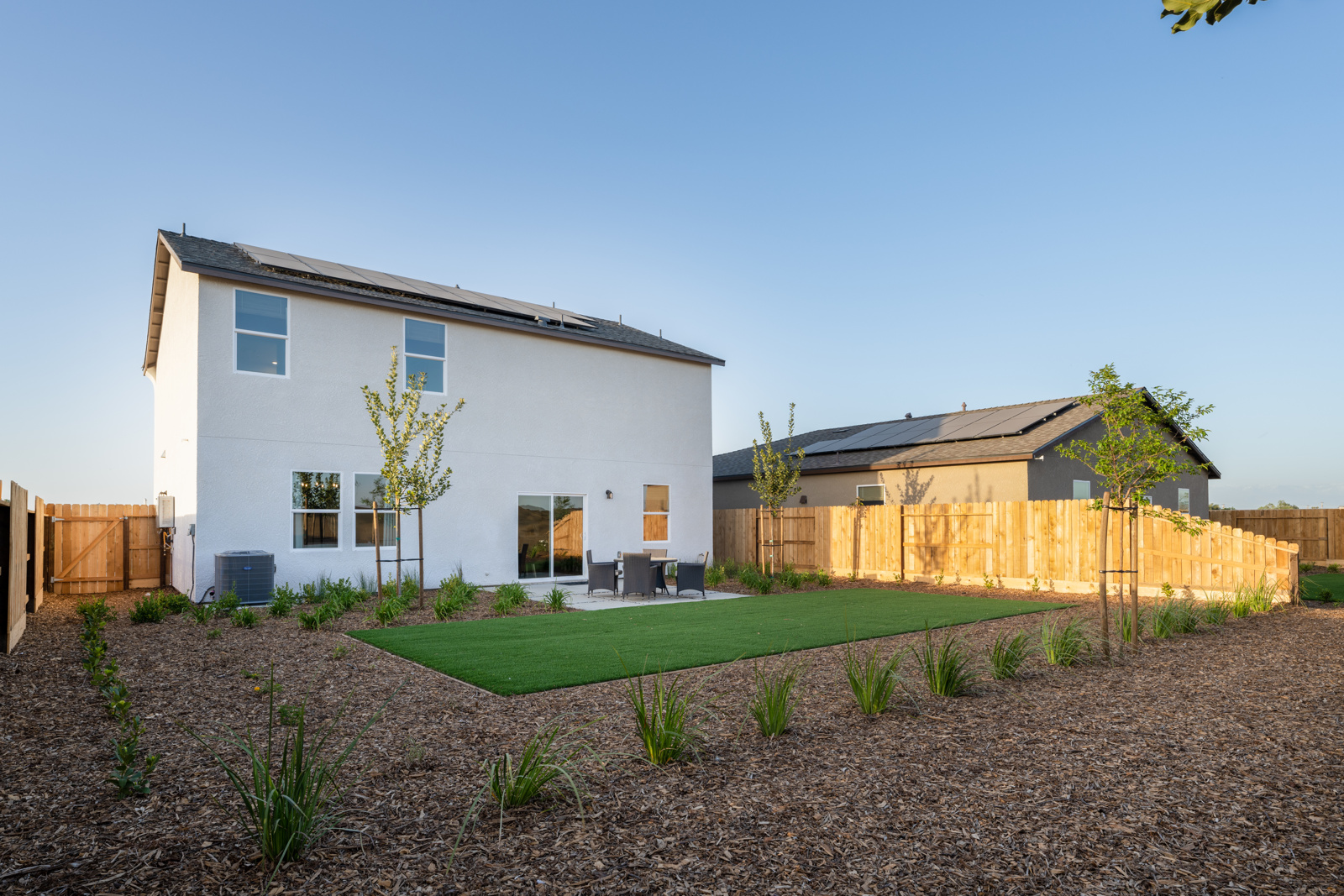 A house with a fence and yard.