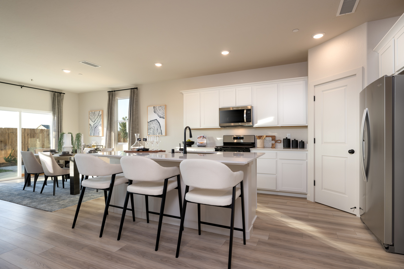A kitchen with white cabinets.