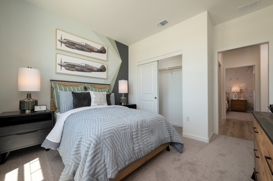 A bedroom with a bed and lamps.