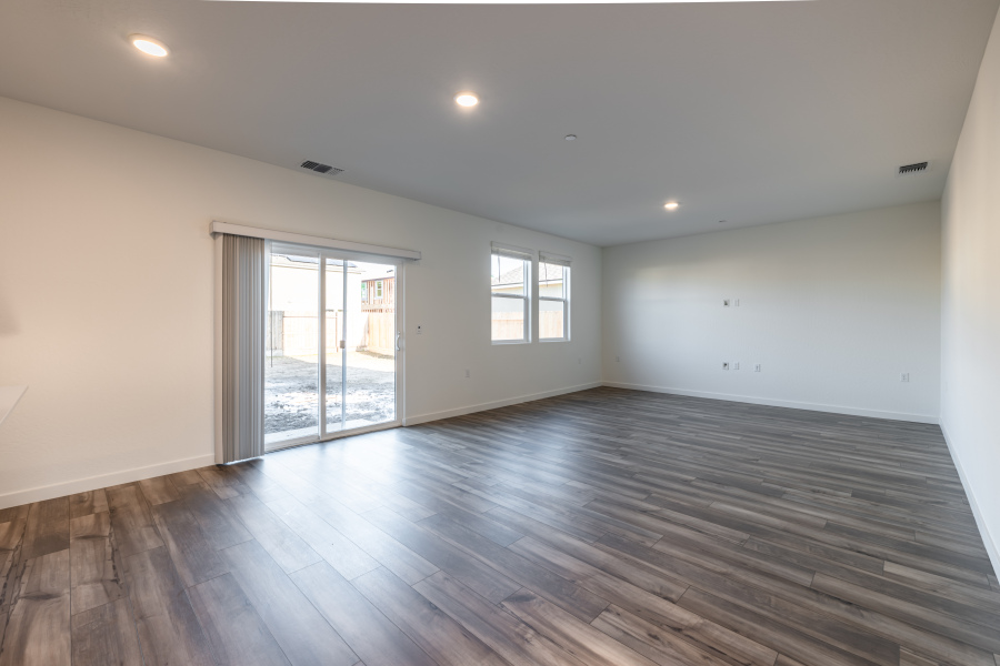 A room with a wood floor and a glass door.