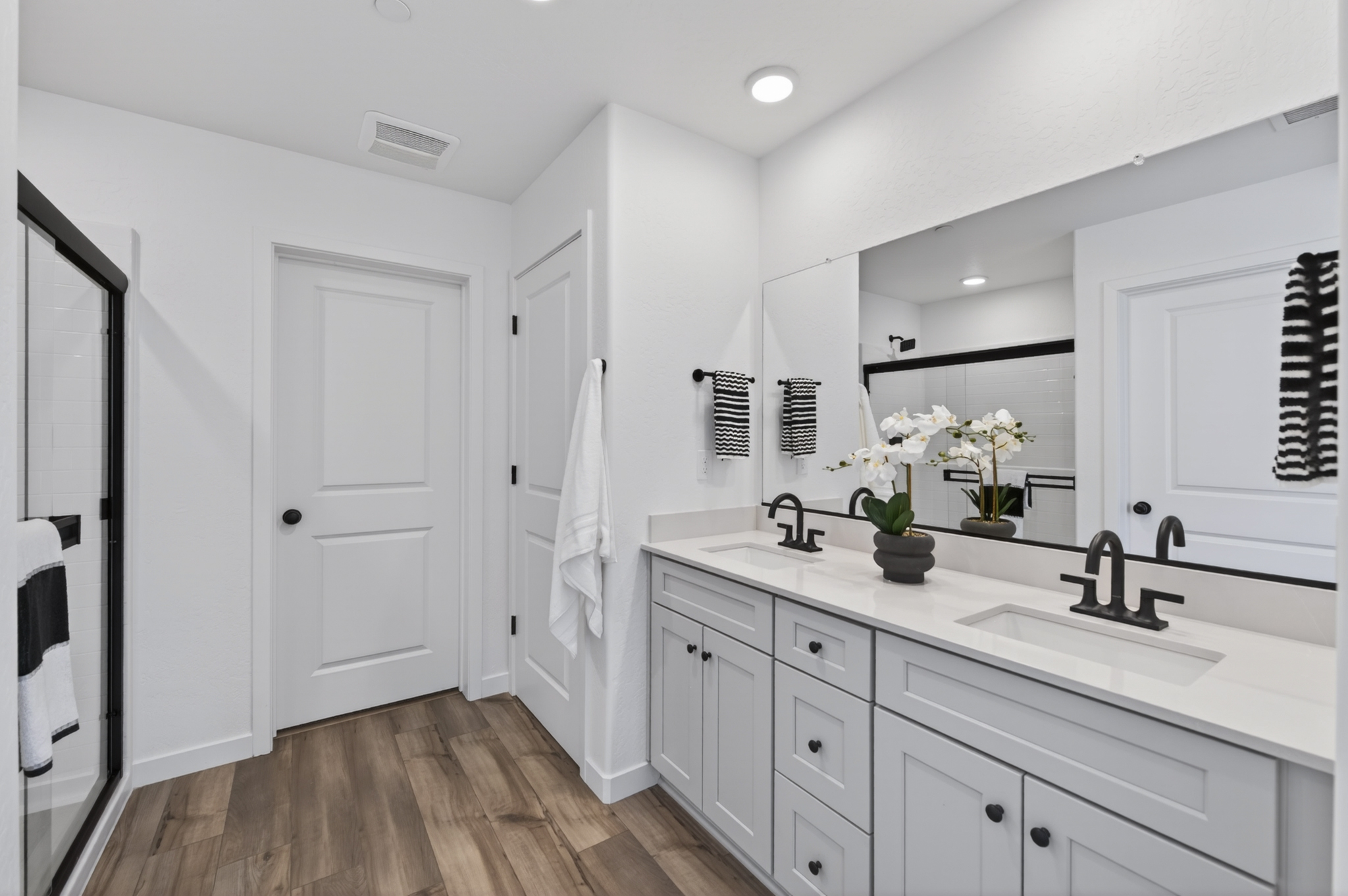 A bathroom with white cabinets.