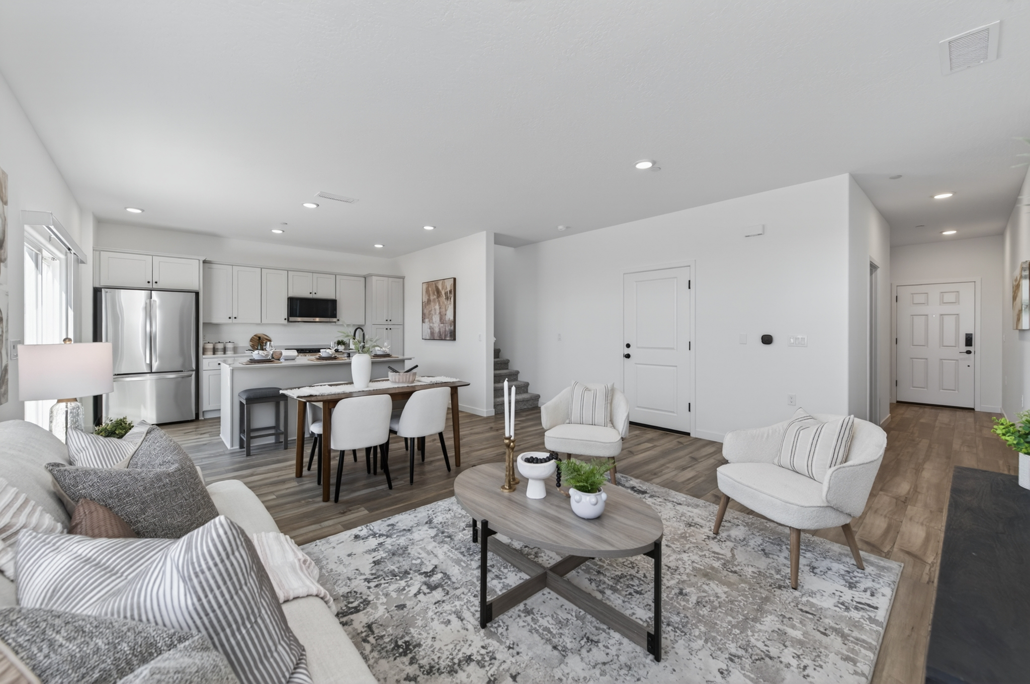 A living room with a dining table and couches.
