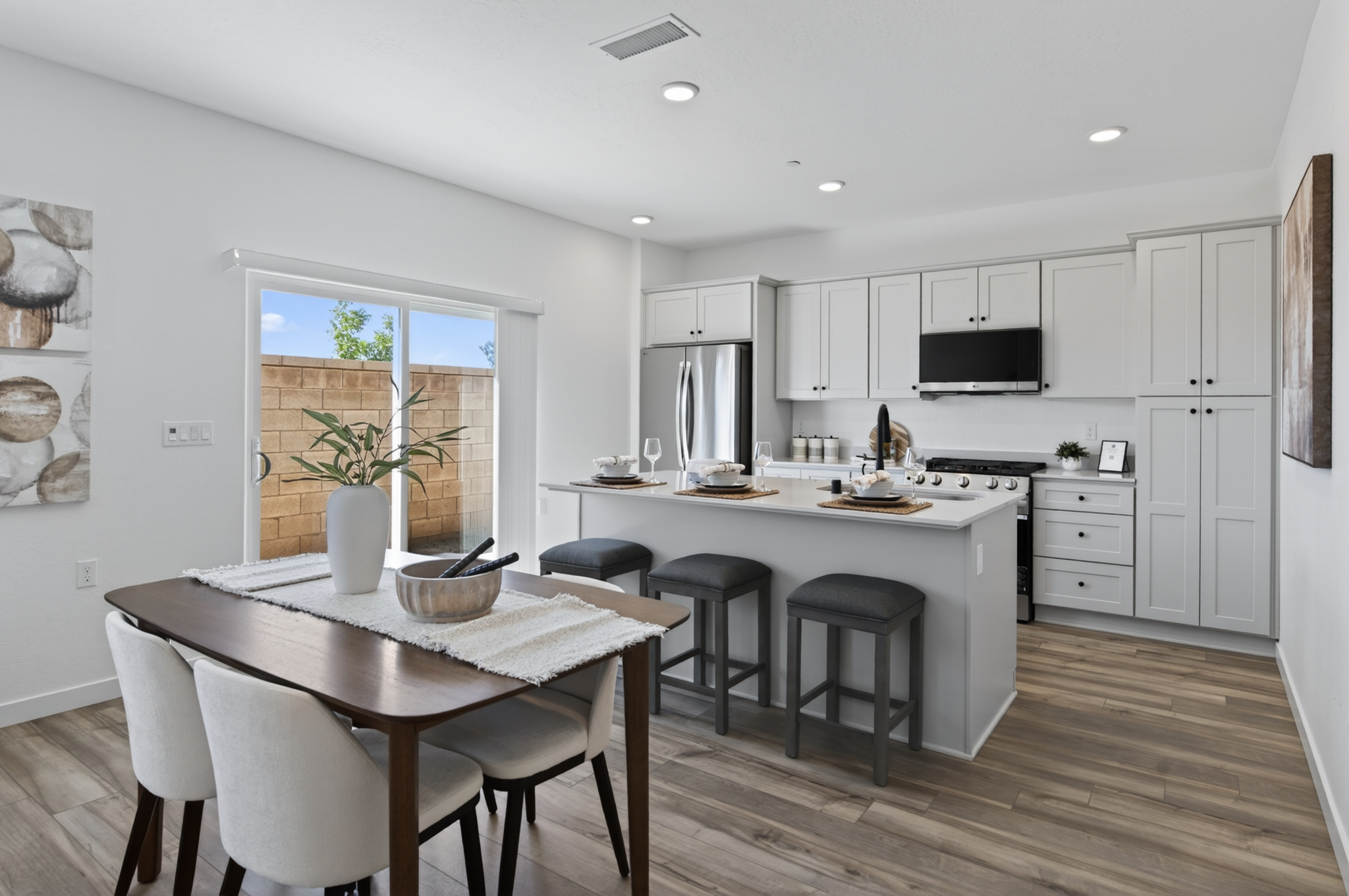 A kitchen with a table and chairs.
