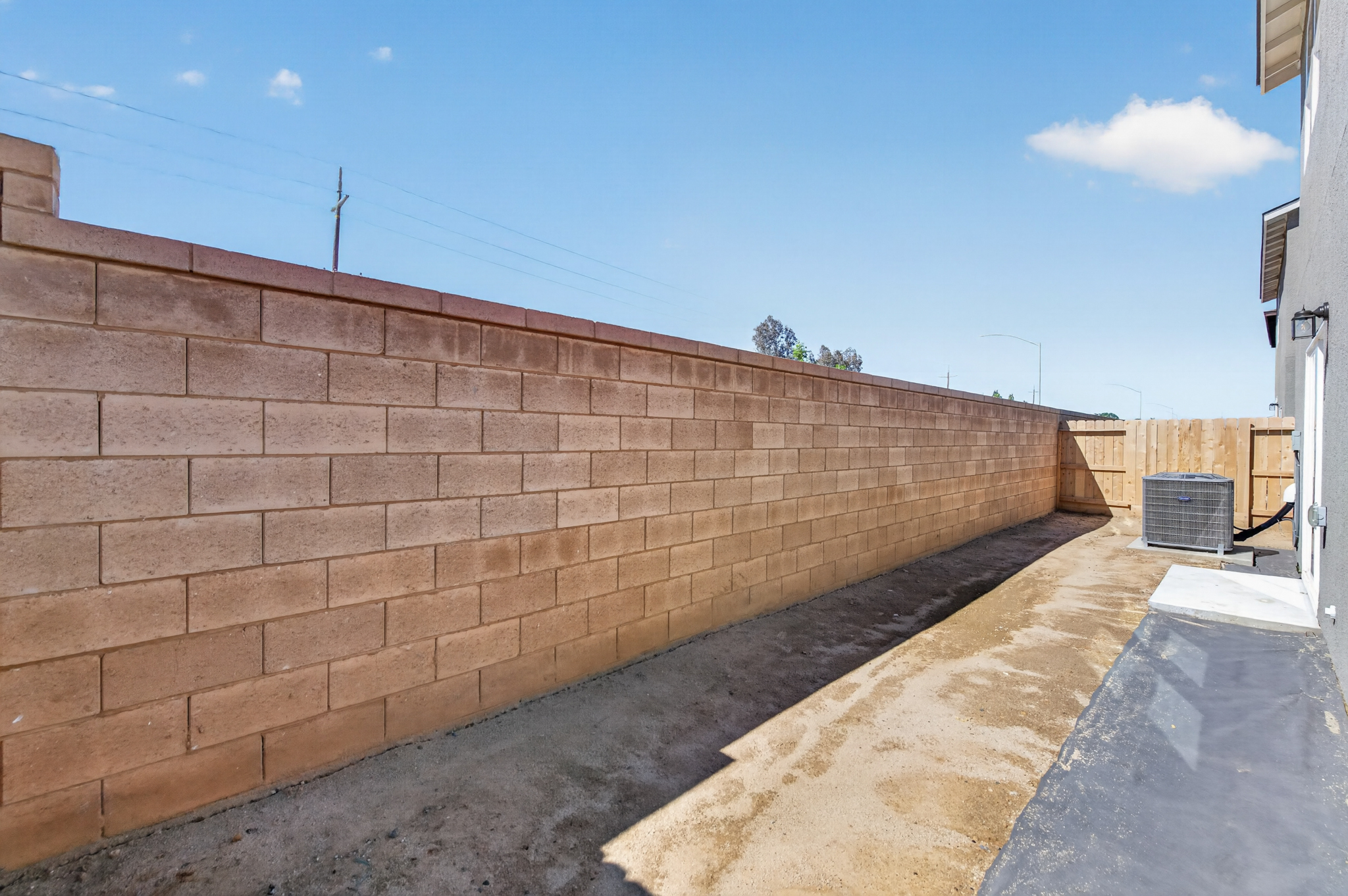 A brick wall with a fence.