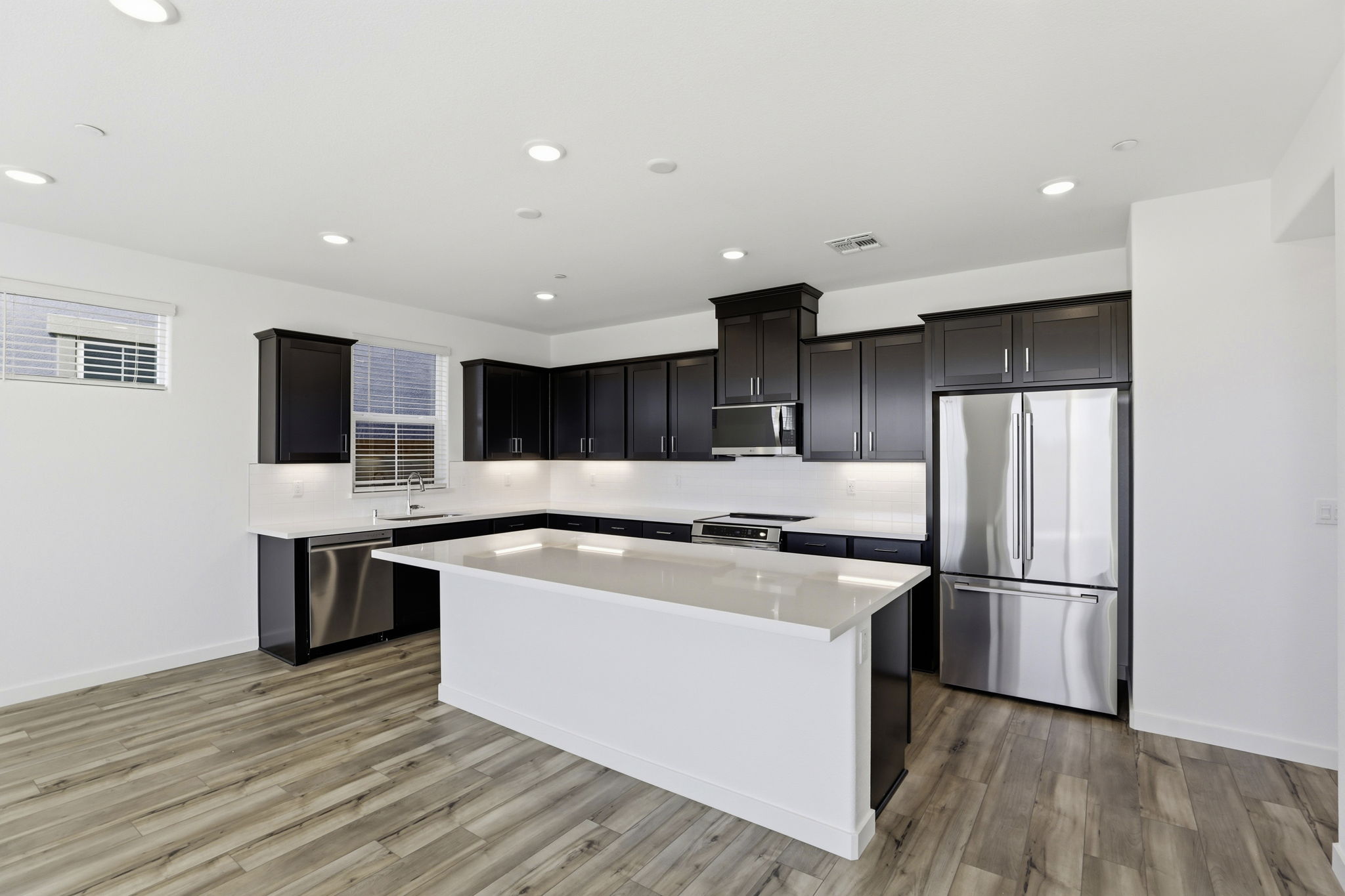 A kitchen with black cabinets.