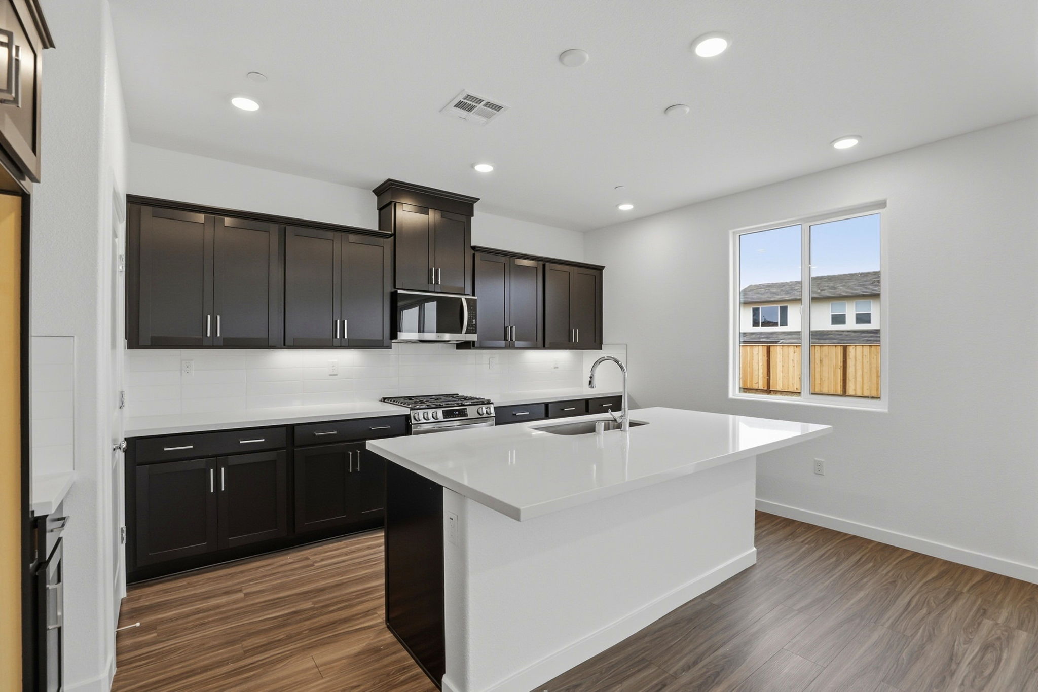 A kitchen with black cabinets.