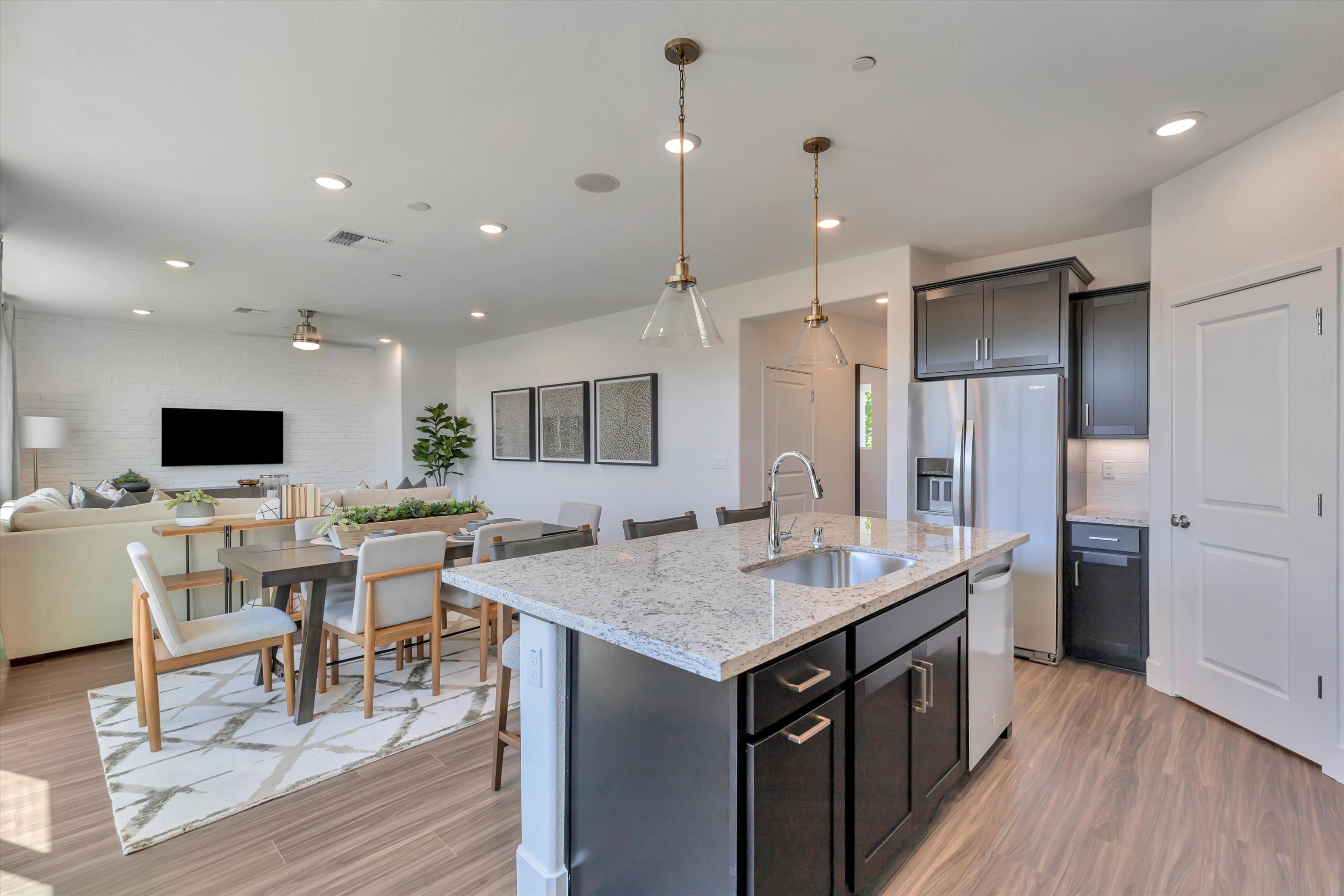 A kitchen with a bar and a table.