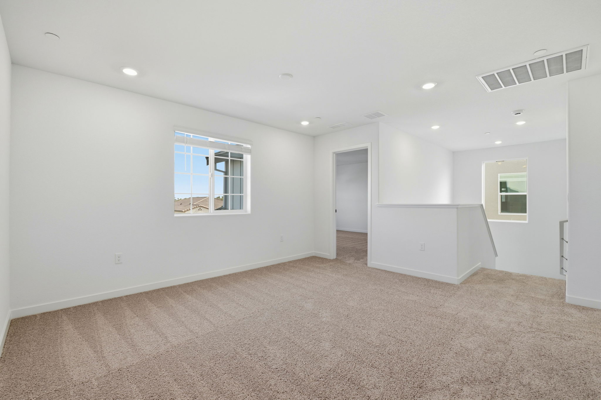 A room with a carpet and a window.
