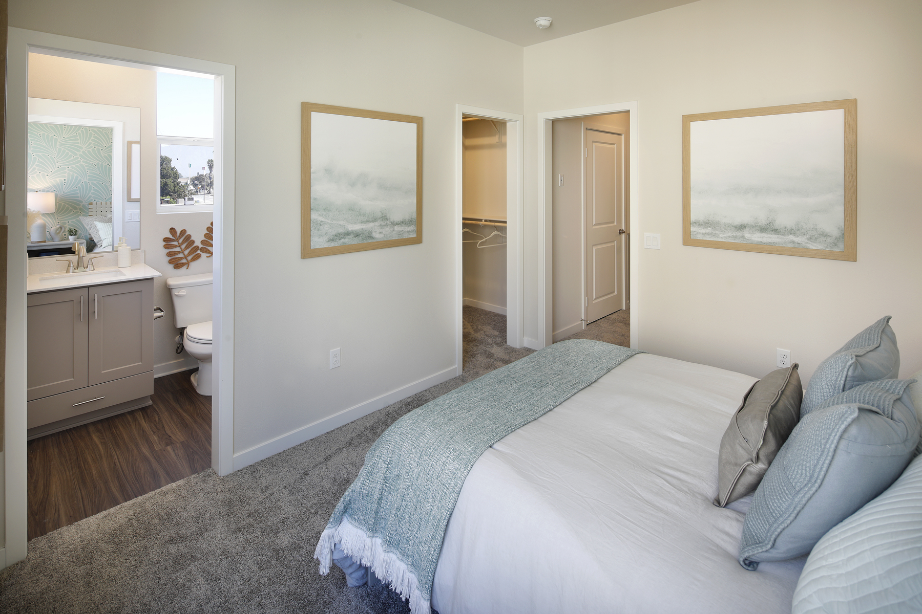 A bedroom with a bed and a mirror.