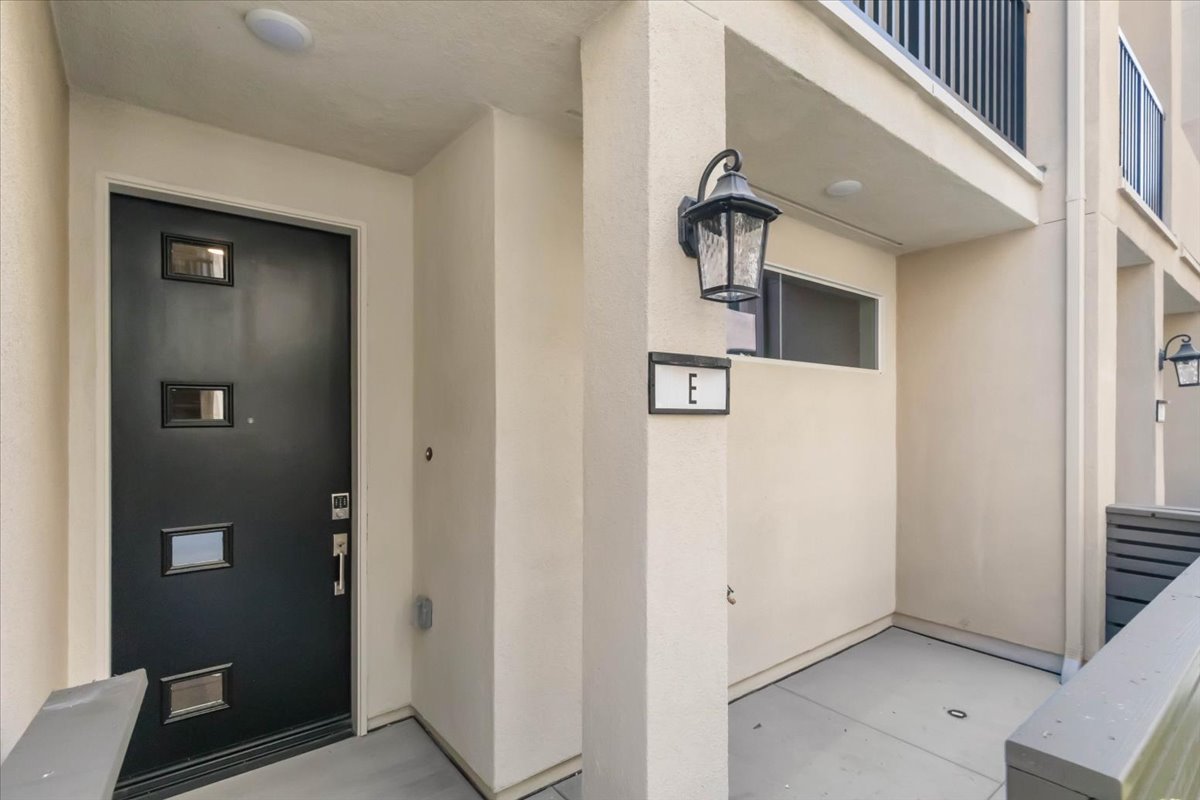 A hallway with a black door.