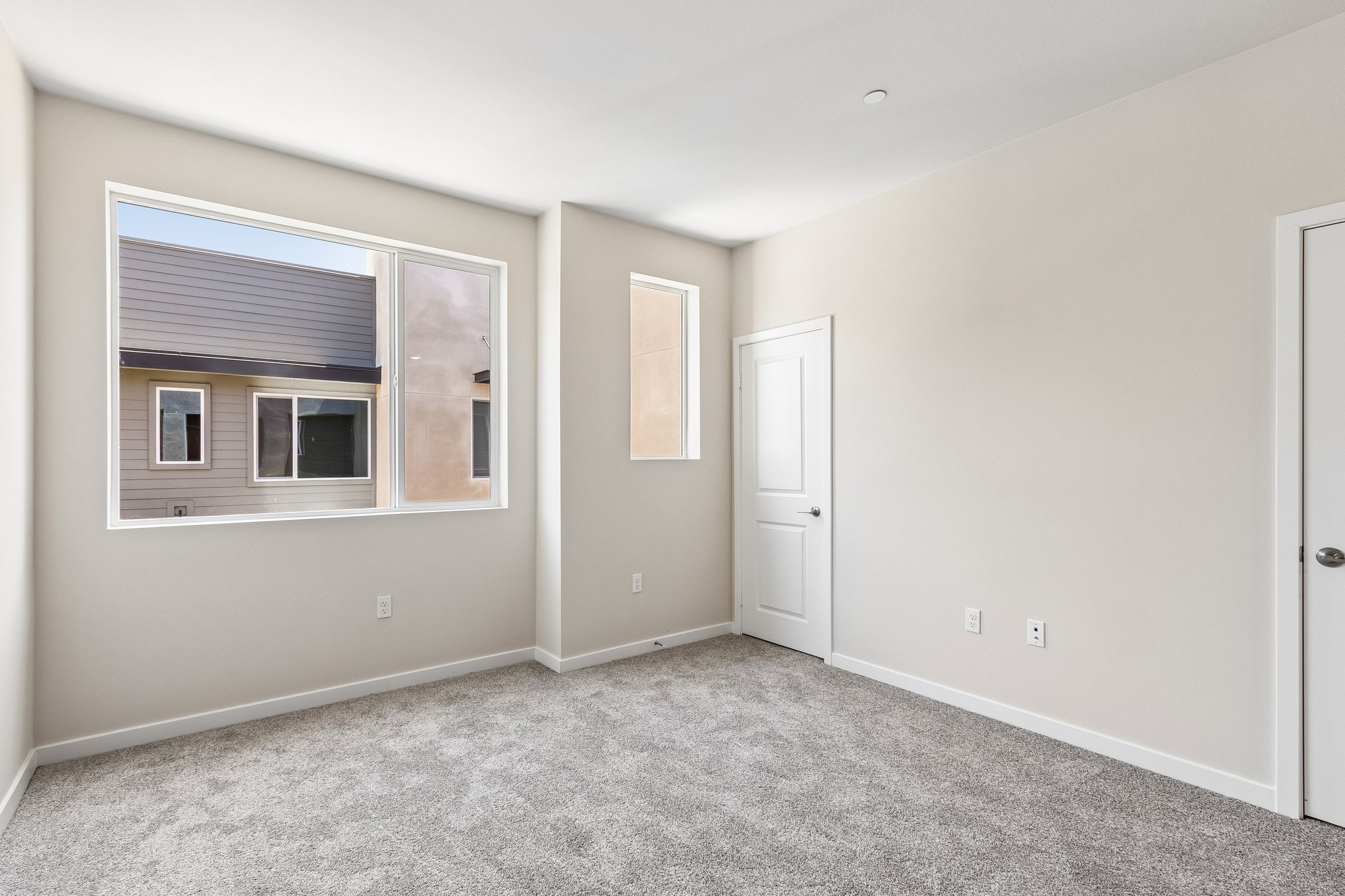 A room with a window and a door.