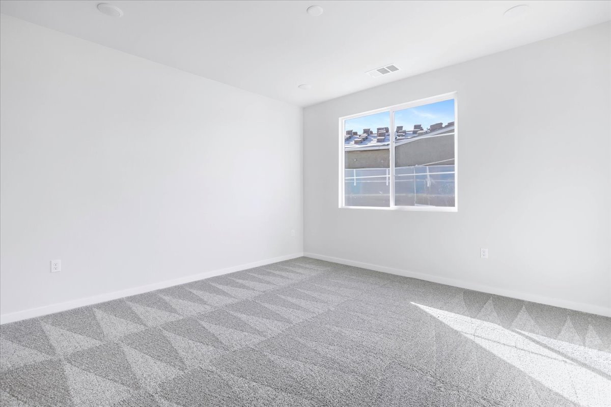 A room with a window and a tile floor.