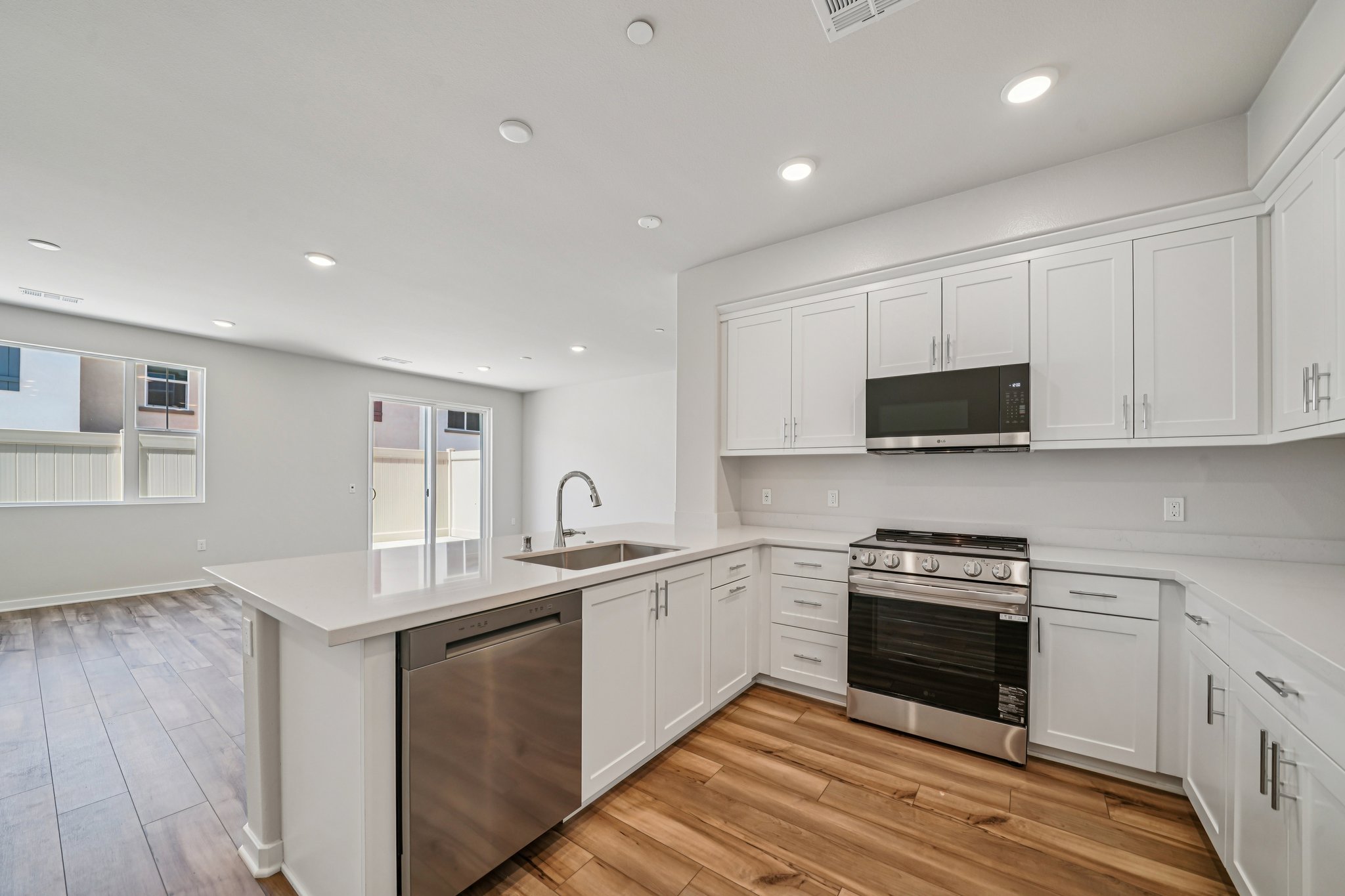 A kitchen with white cabinets.