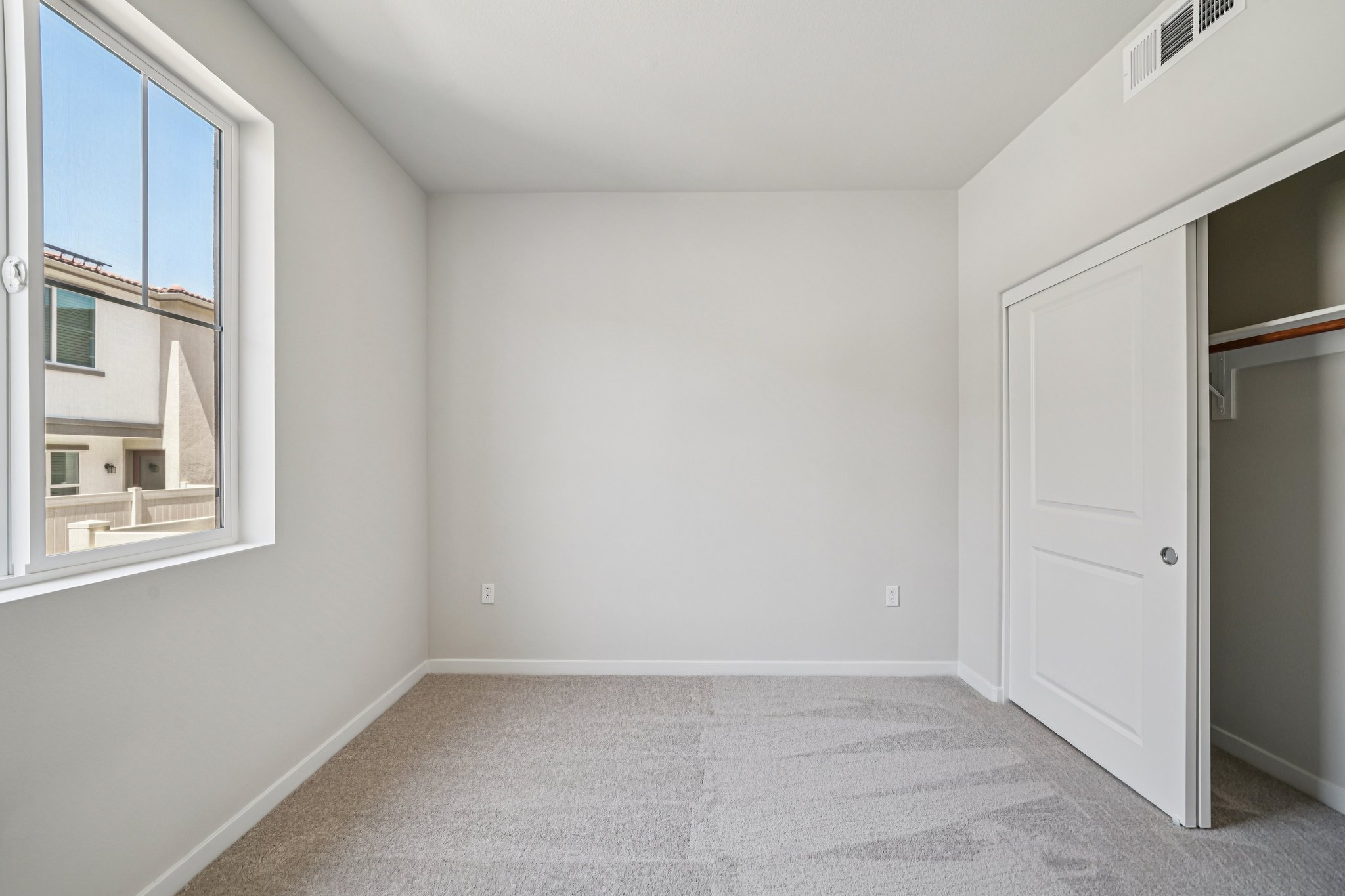 A room with a white door and a window.