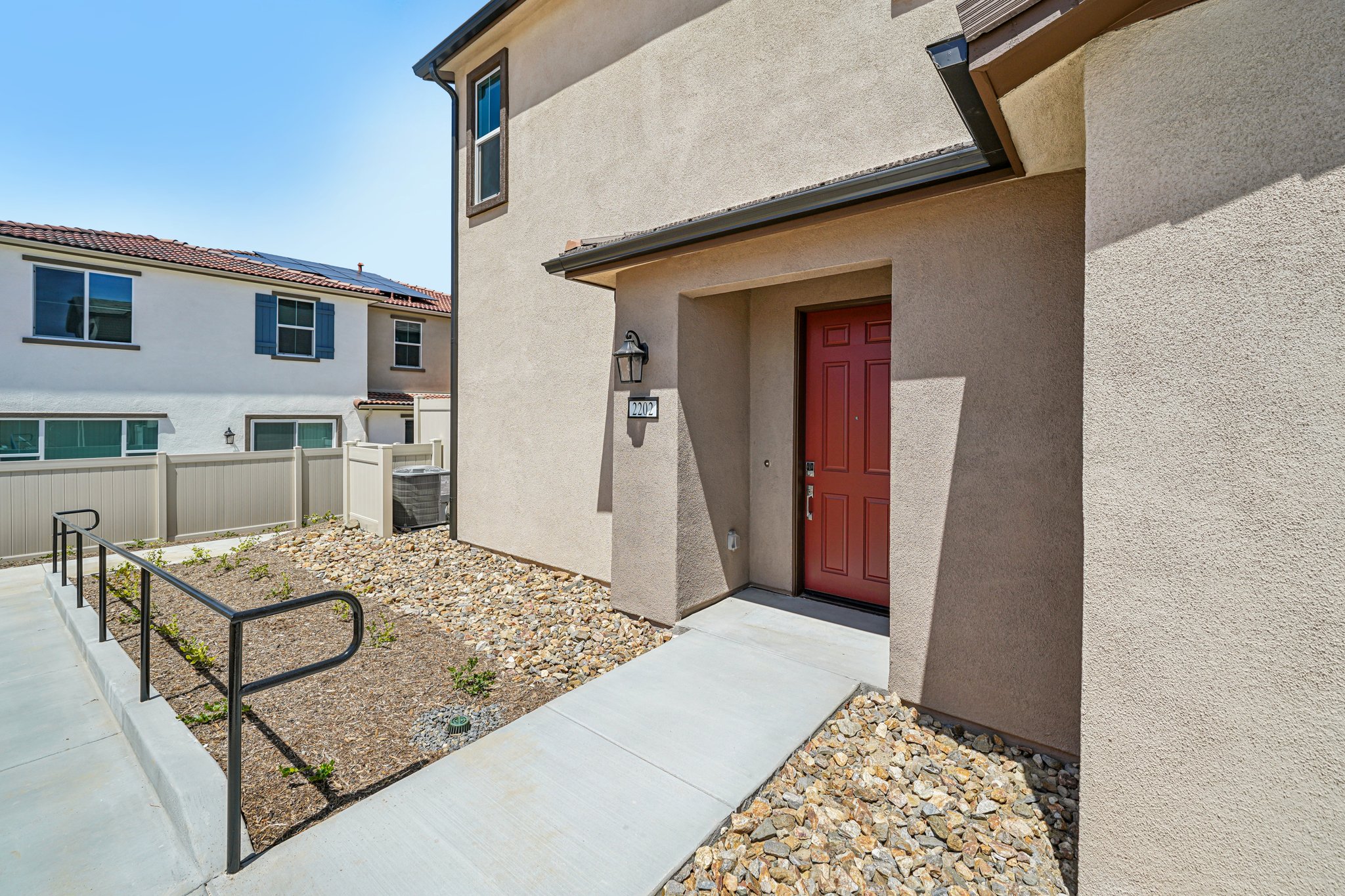 A house with a fence and a brick patio.
