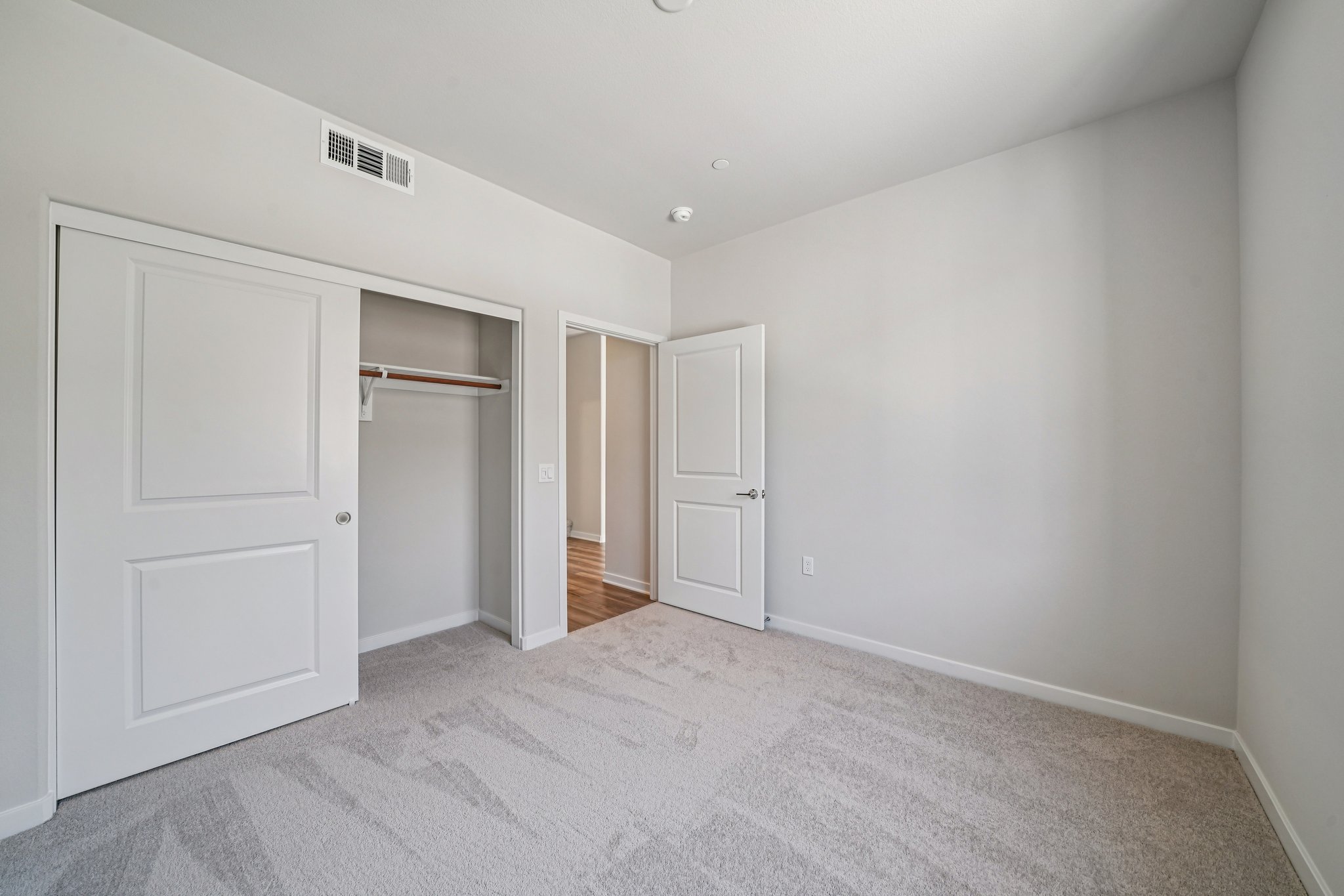 A hallway with white doors.