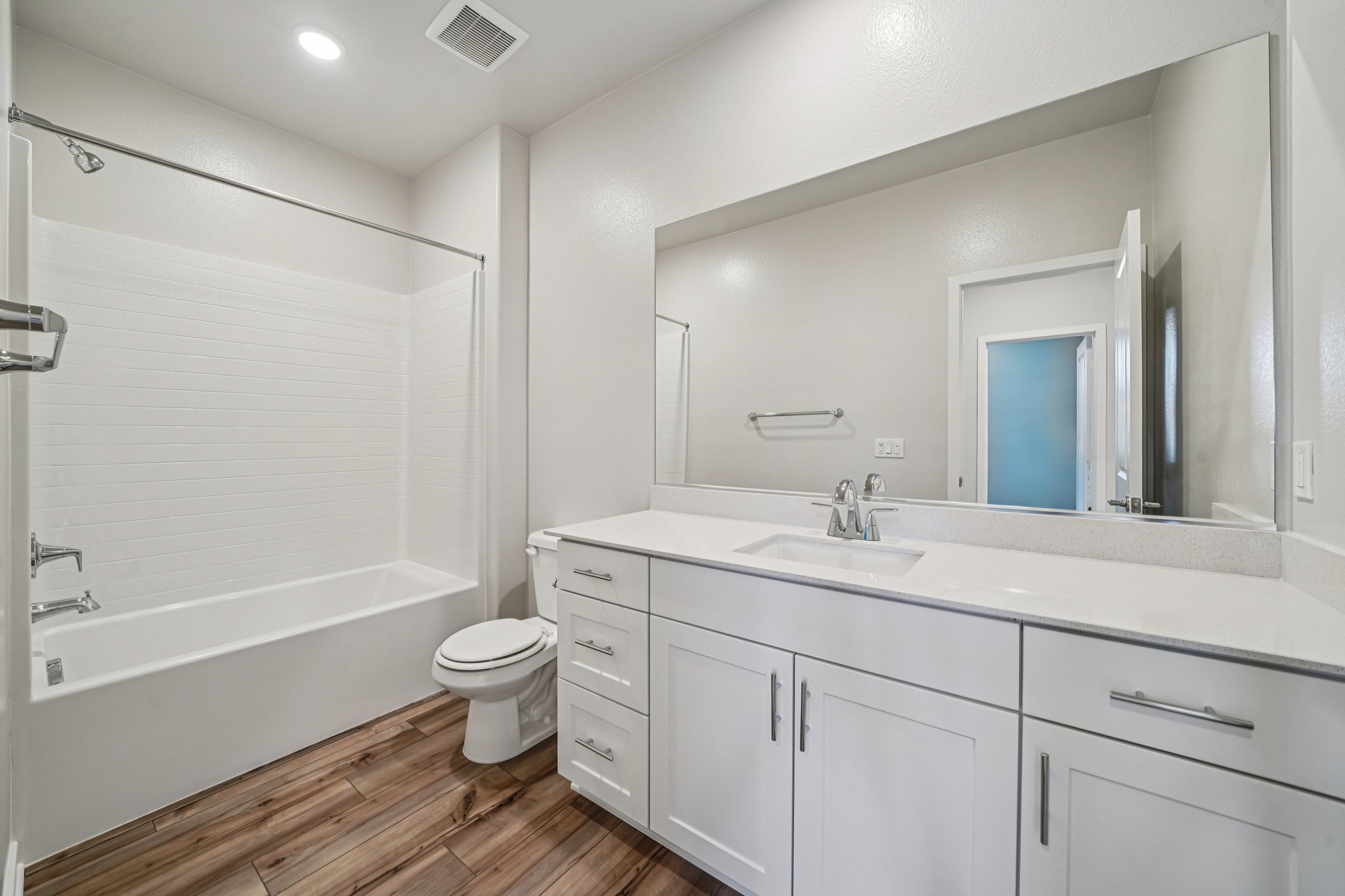 A bathroom with a tub sink and toilet.