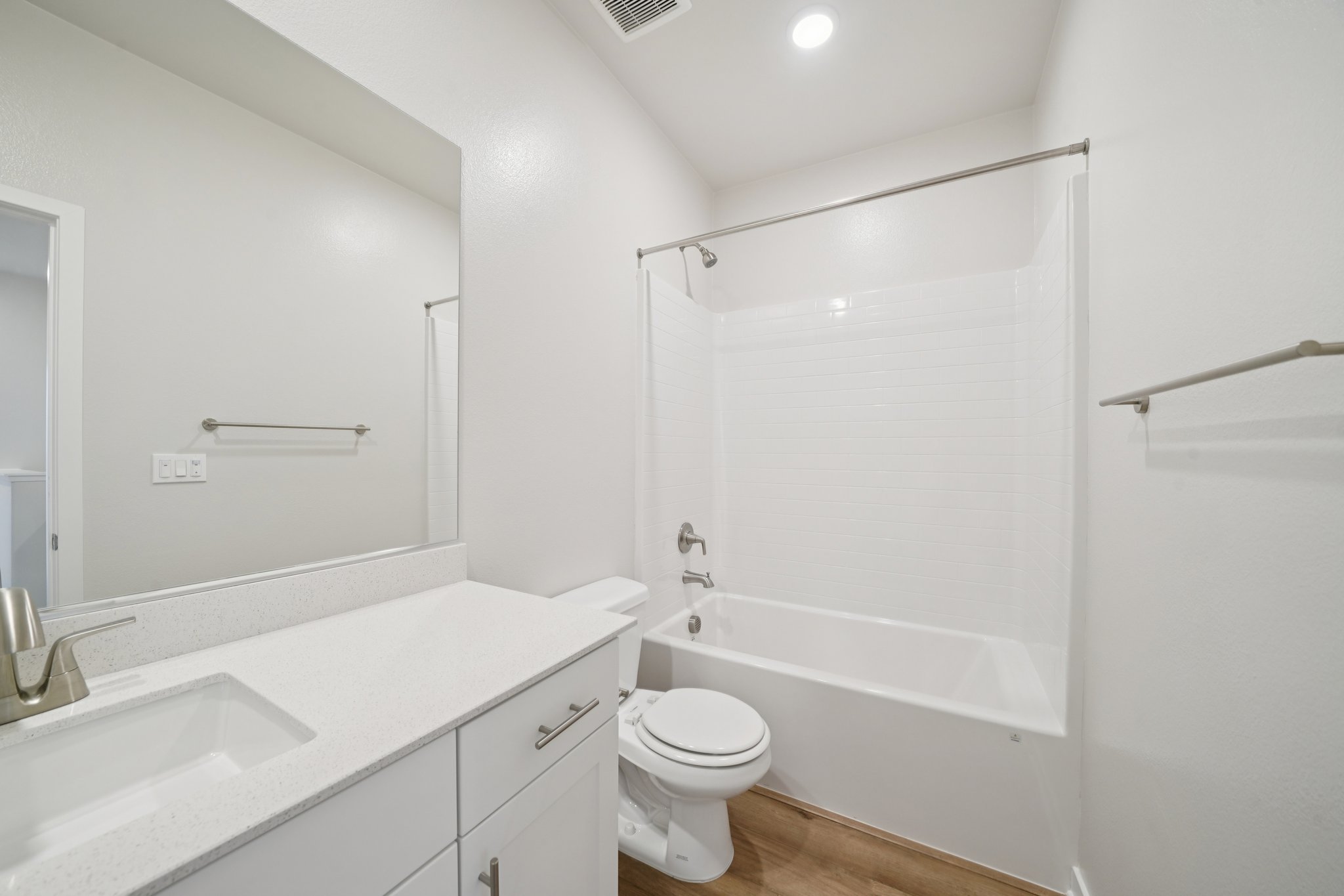 A bathroom with a tub sink and toilet.