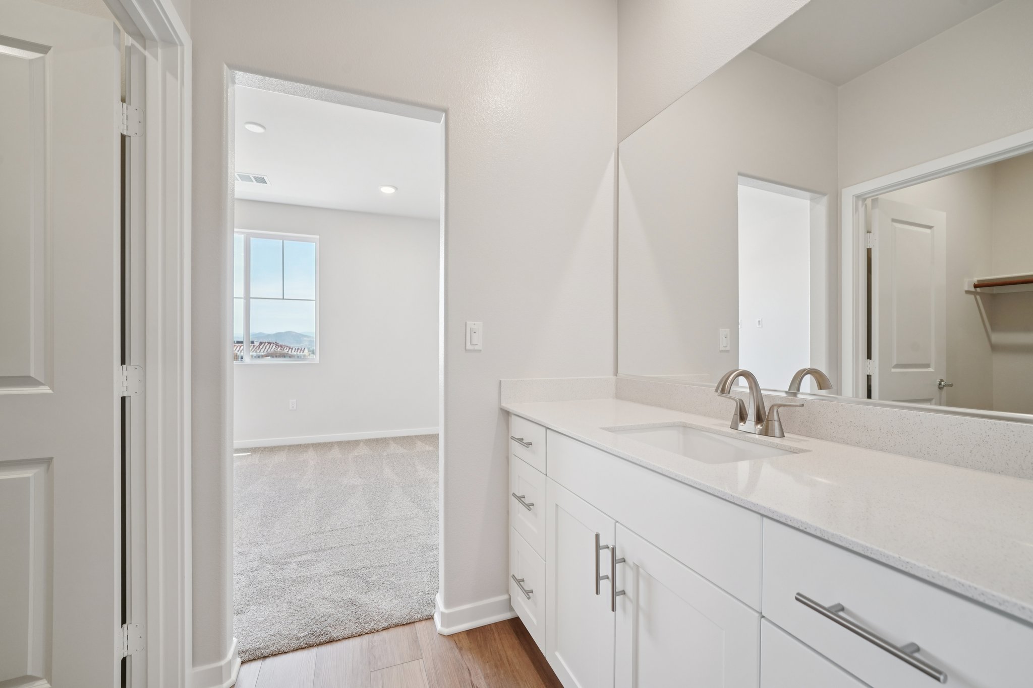 A bathroom with white cabinets.