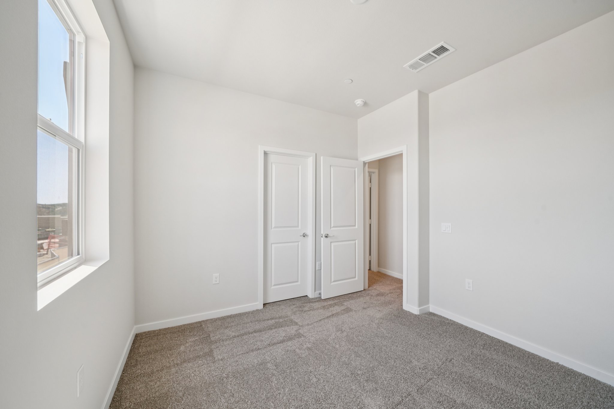 A hallway with white doors.