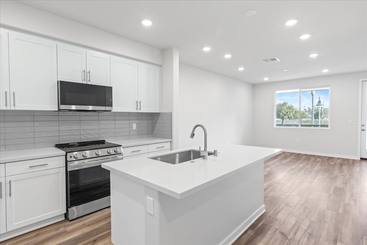 A kitchen with white cabinets.