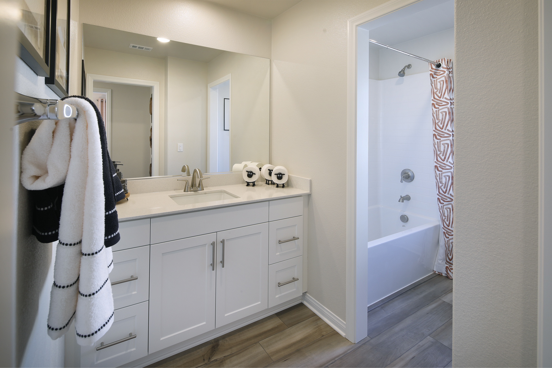 A bathroom with a sink and a shower.