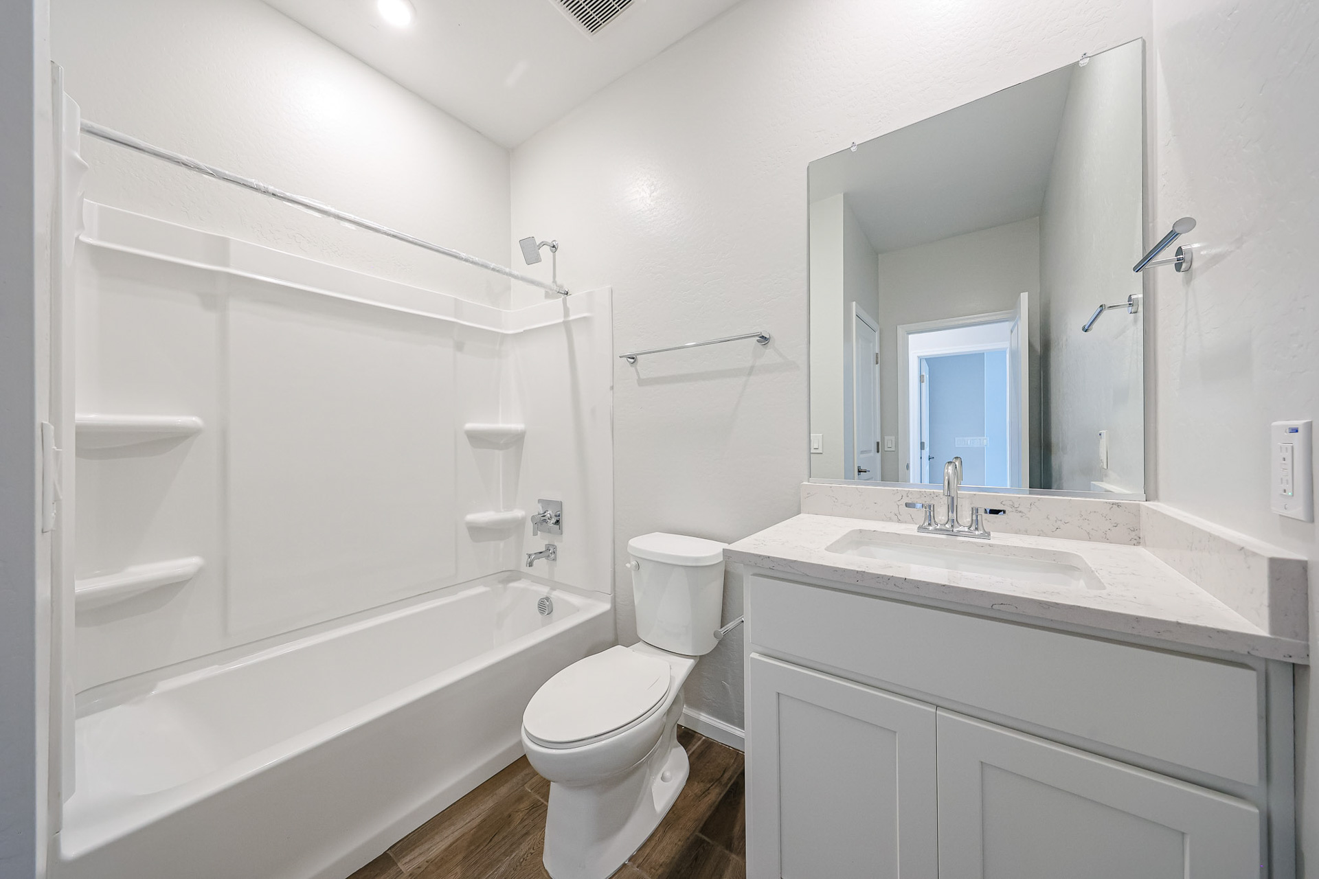 A bathroom with a tub toilet and sink.
