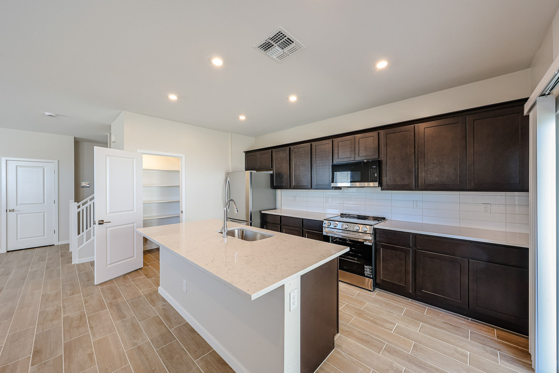 A kitchen with black cabinets.