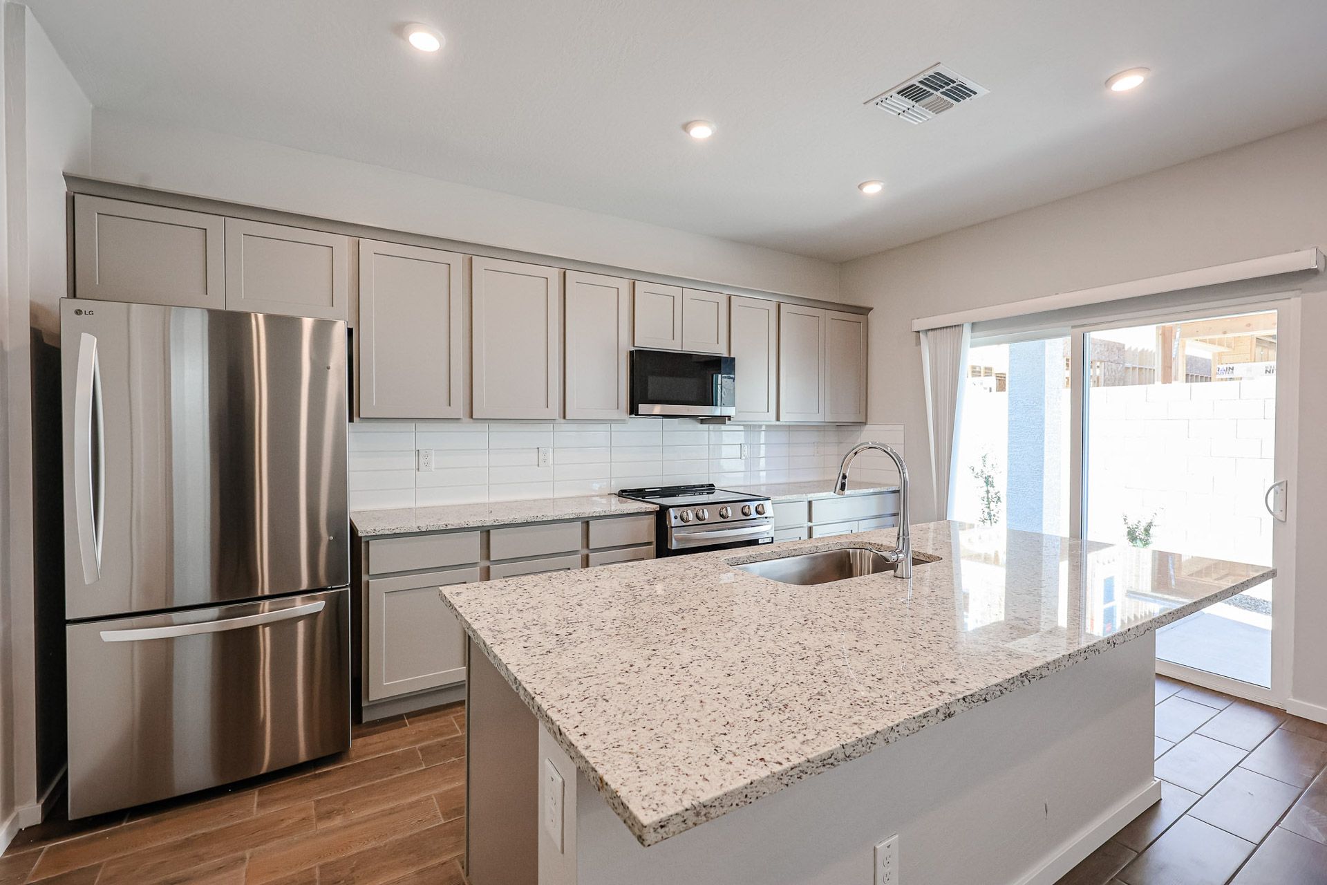 A kitchen with white cabinets.