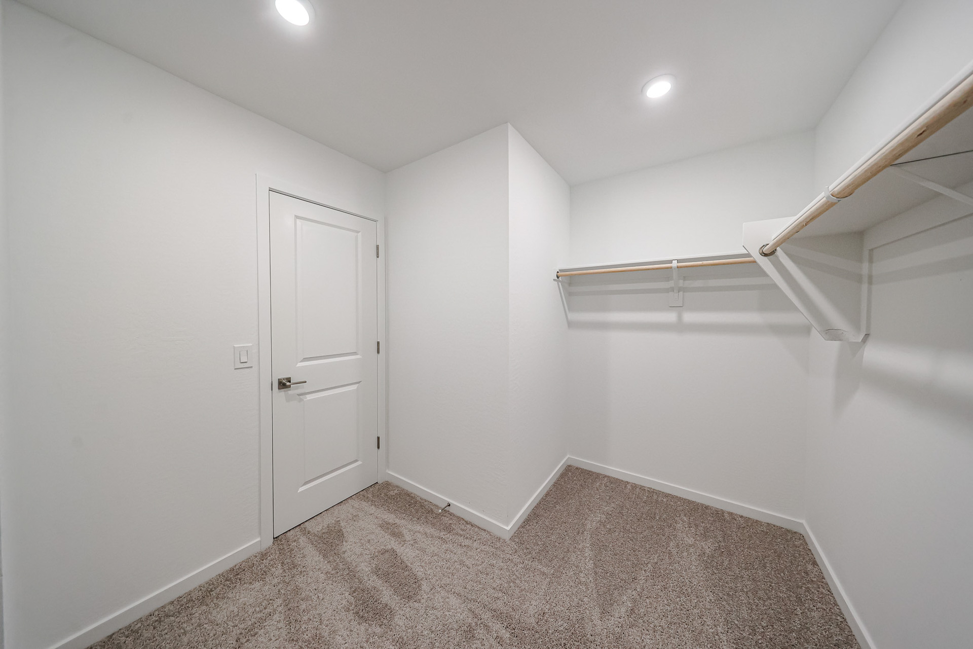 A room with white walls and a staircase.