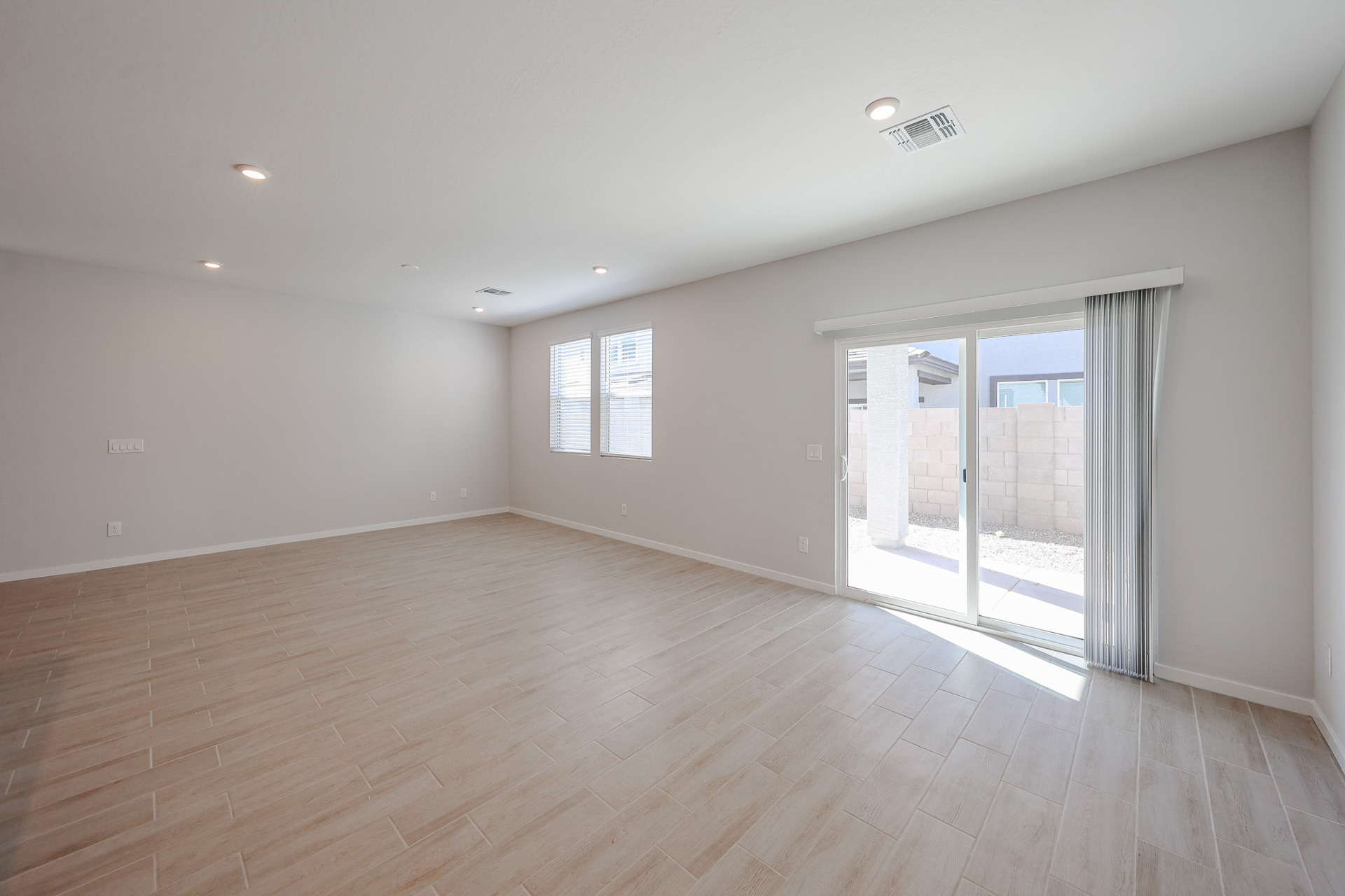 A room with a wood floor and a glass door.