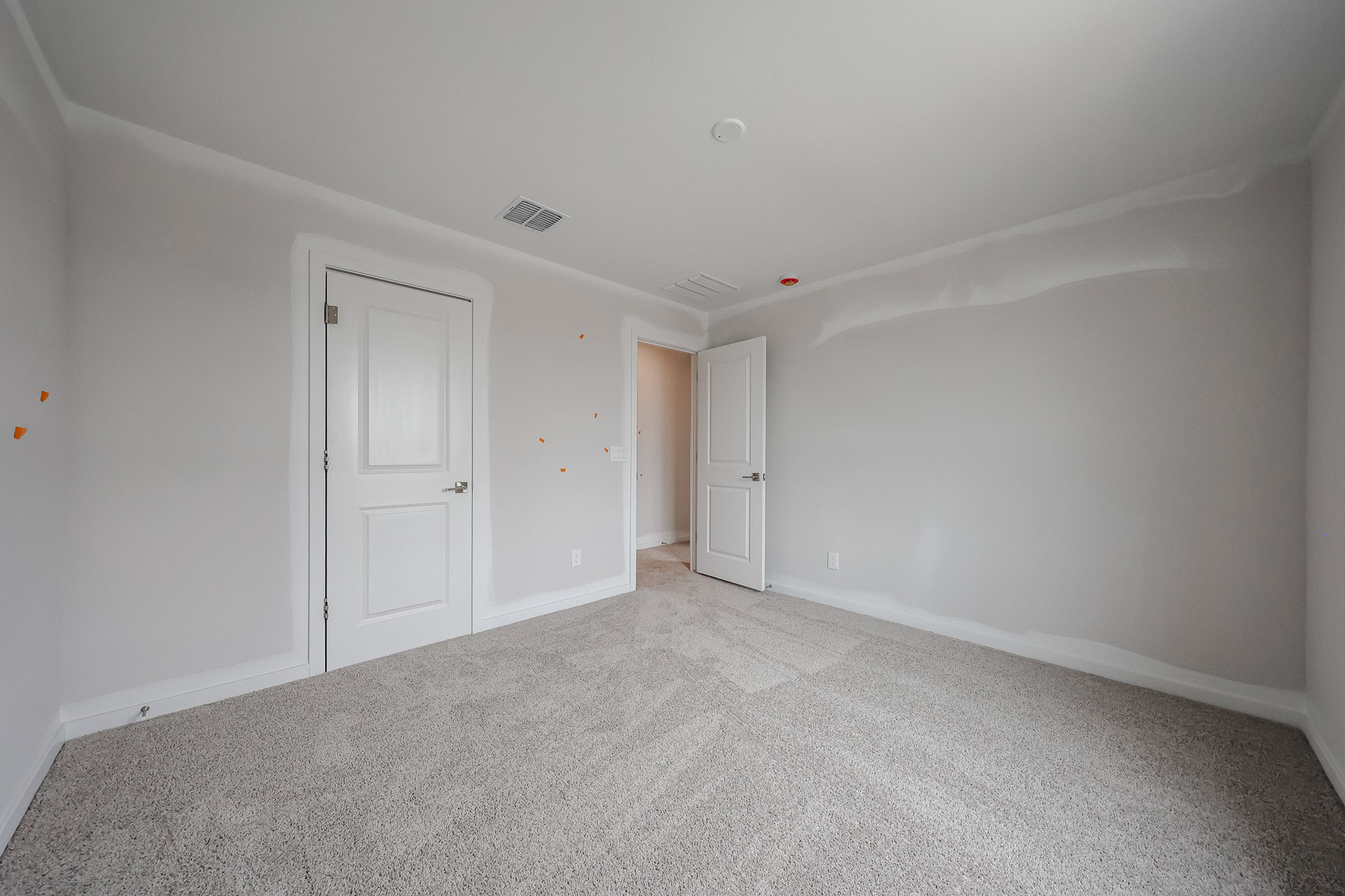 A hallway with white doors.