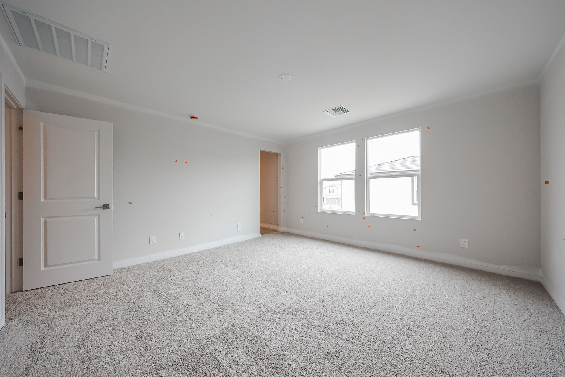 A room with white walls and a carpeted floor.