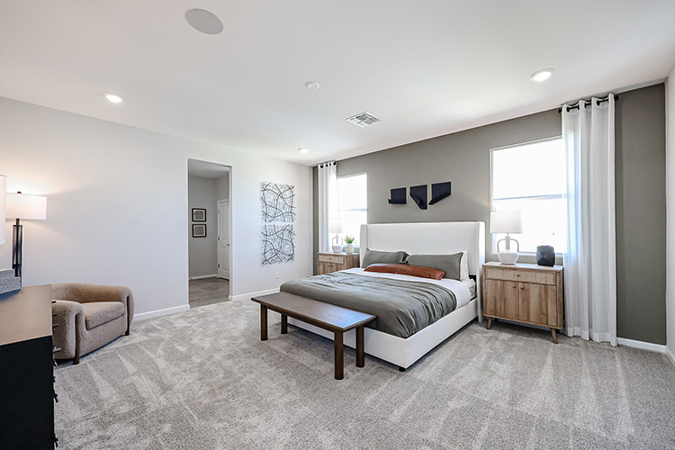 A bedroom with a bed and a bench.