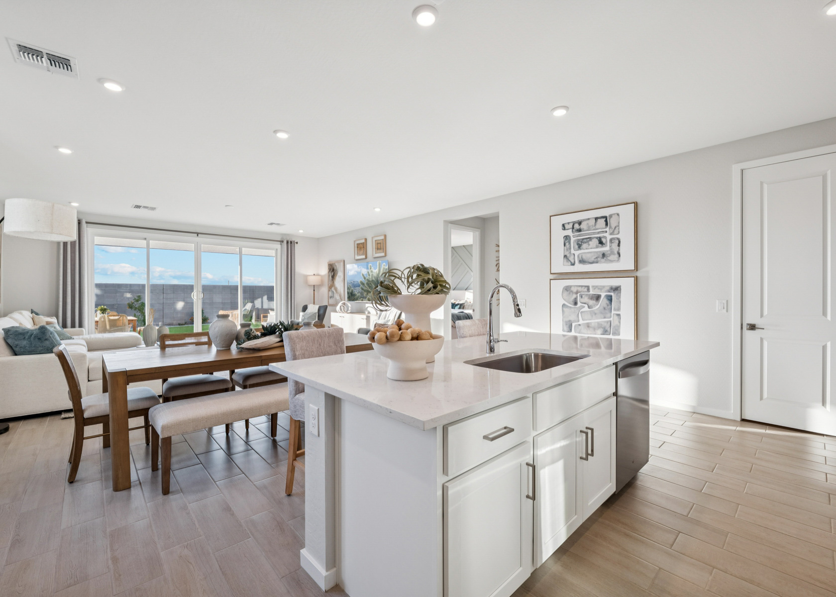 A kitchen with a table and chairs.