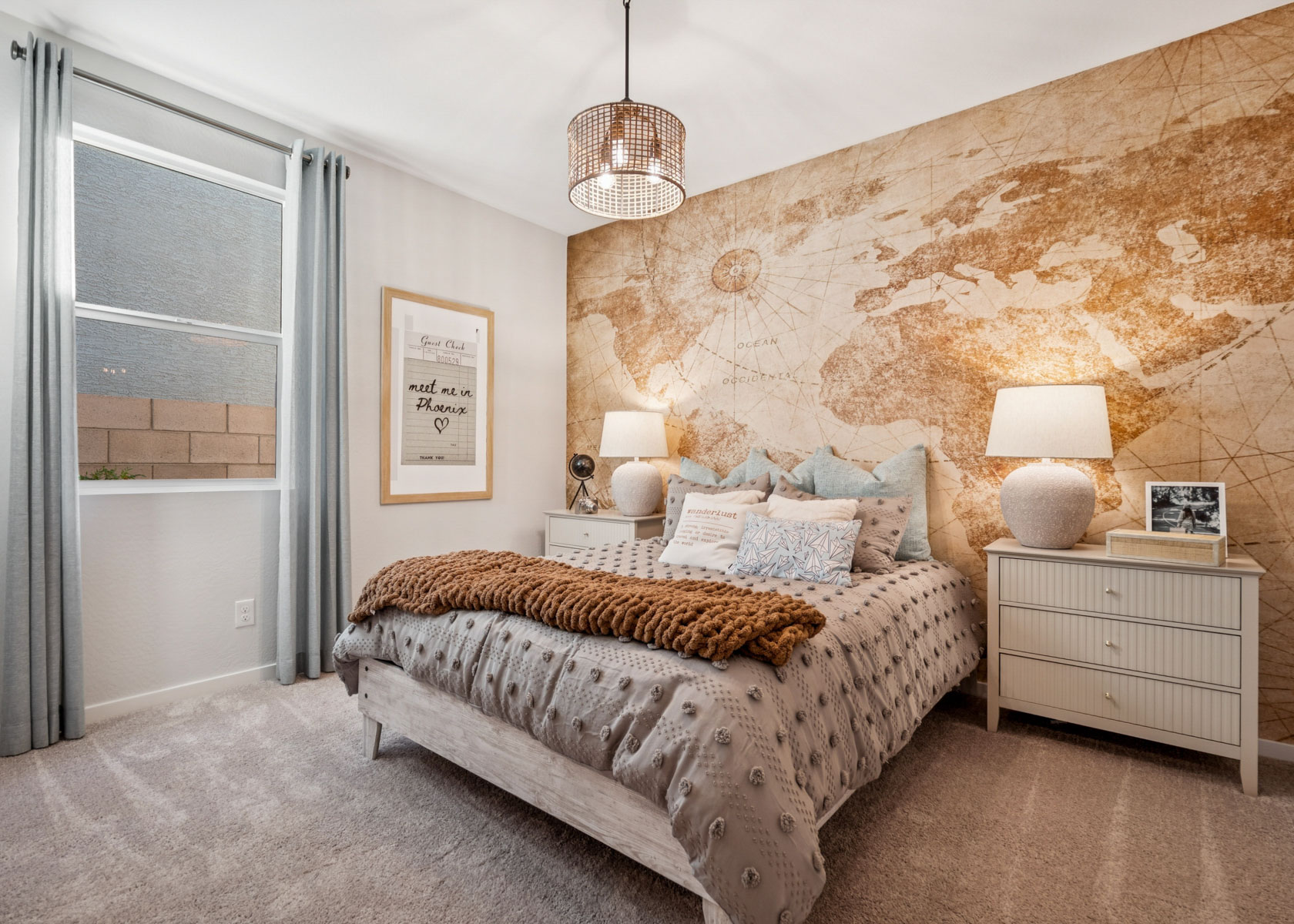 A bedroom with a bed and lamps.