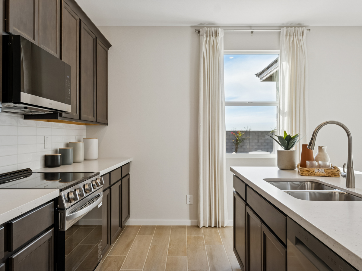 A kitchen with a stove and a sink.
