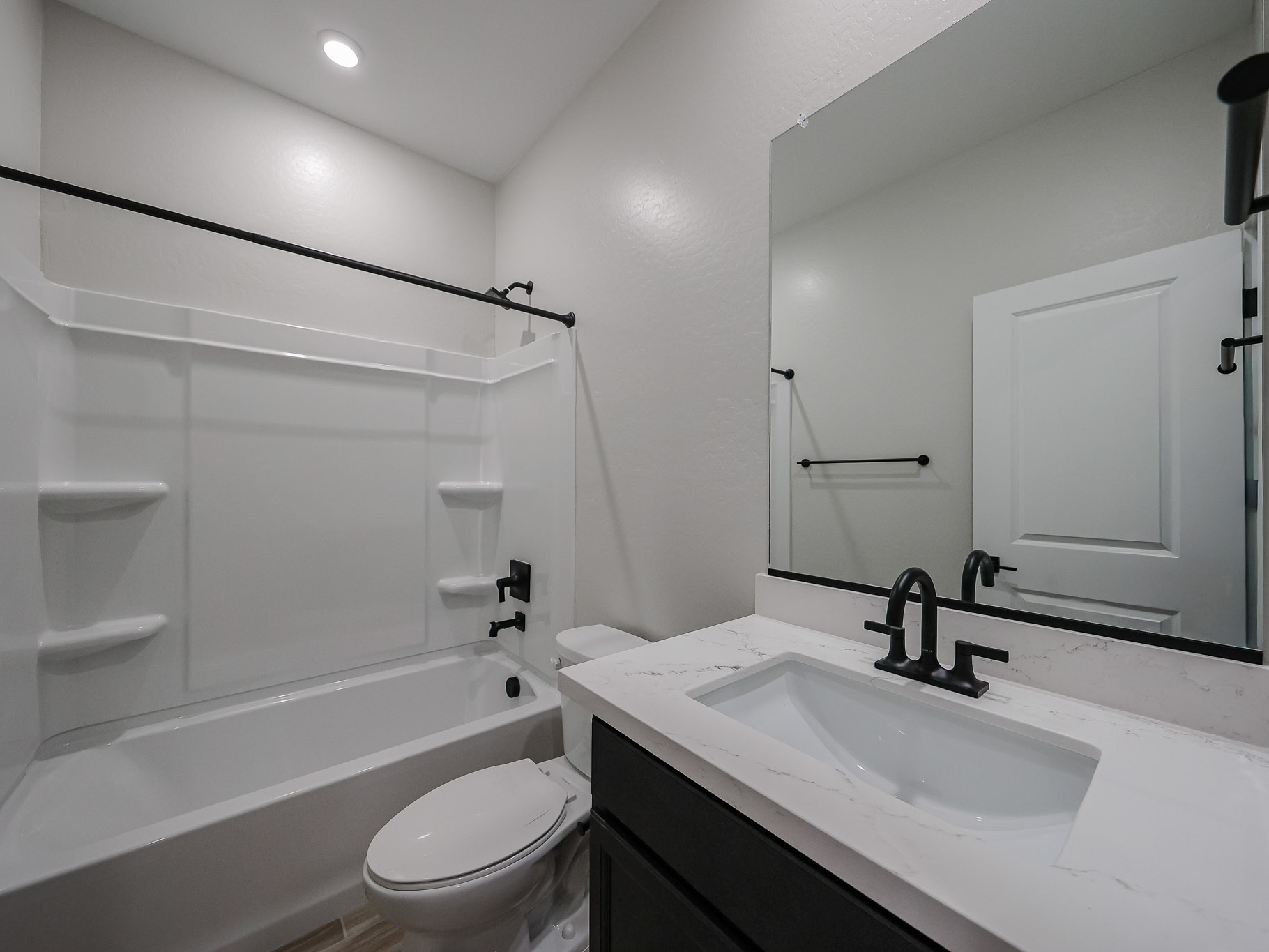 A bathroom with a tub sink and toilet.