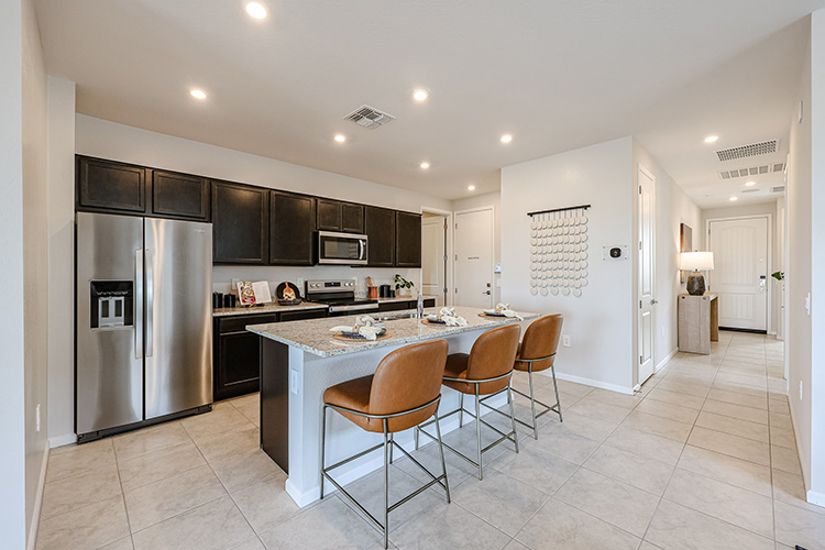 A kitchen with a table and chairs.