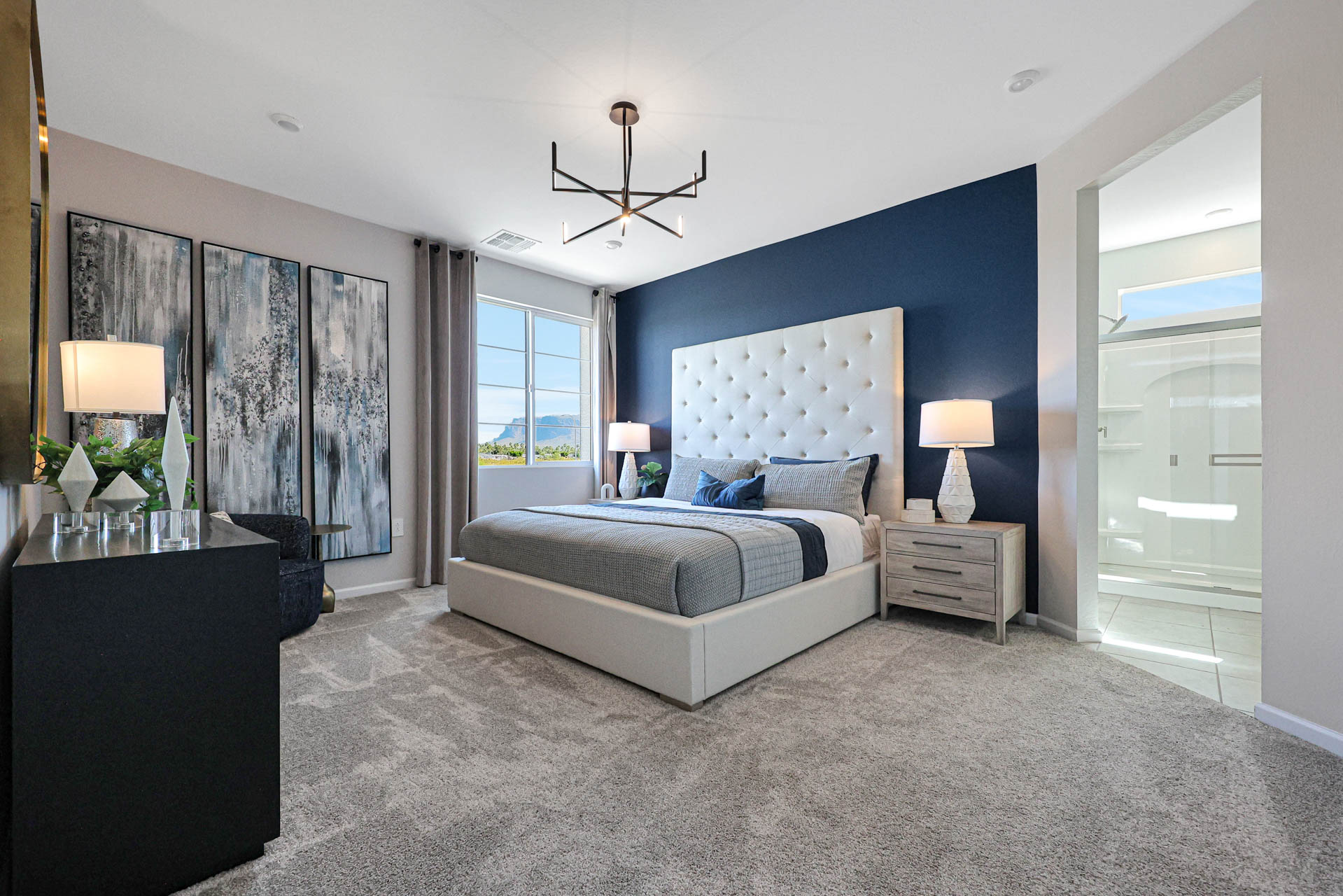 A bedroom with a bed and a table.