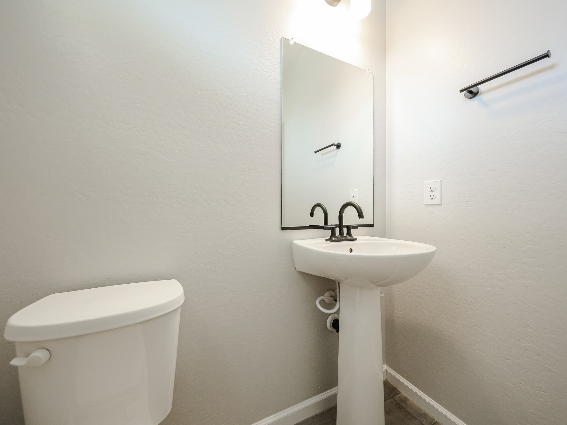 A bathroom with a sink and toilet.