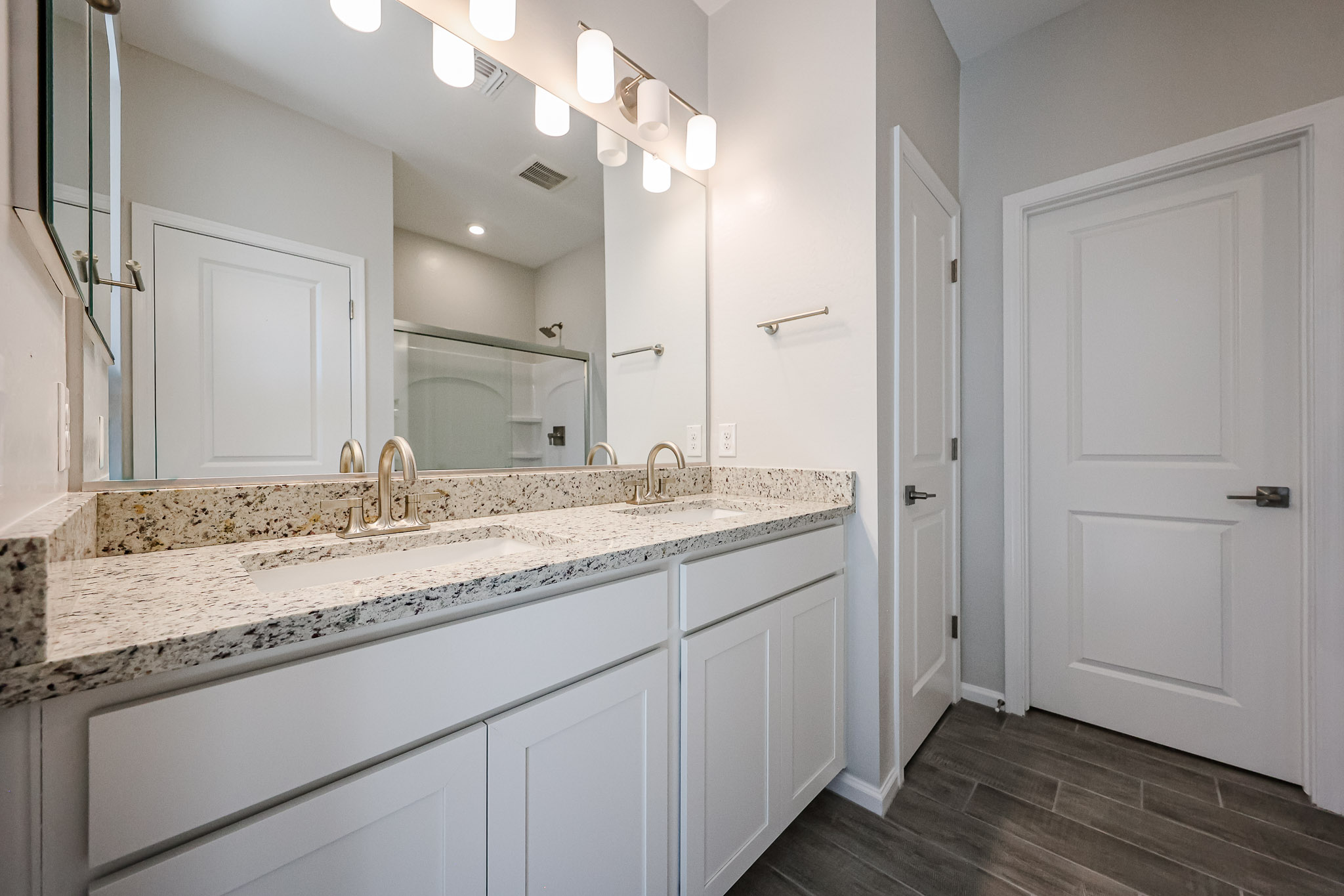 A bathroom with a marble countertop.