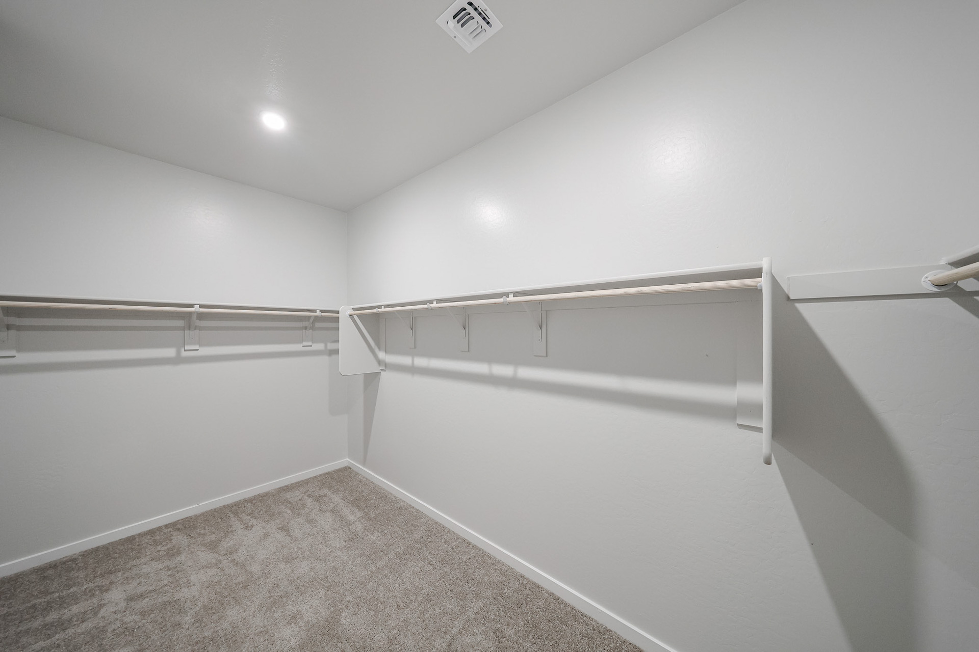 A white wall with a metal railing.