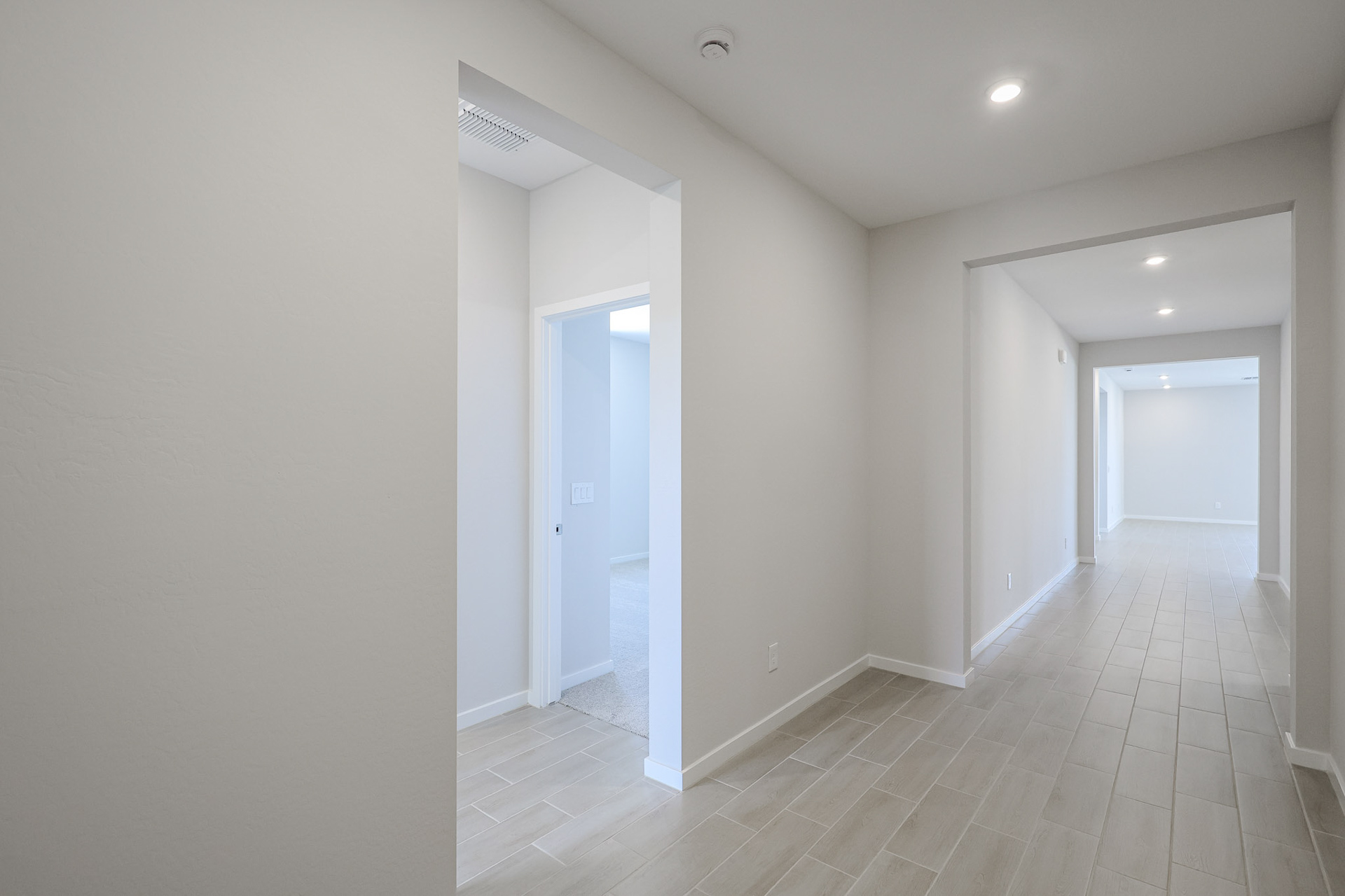 A hallway with white walls.
