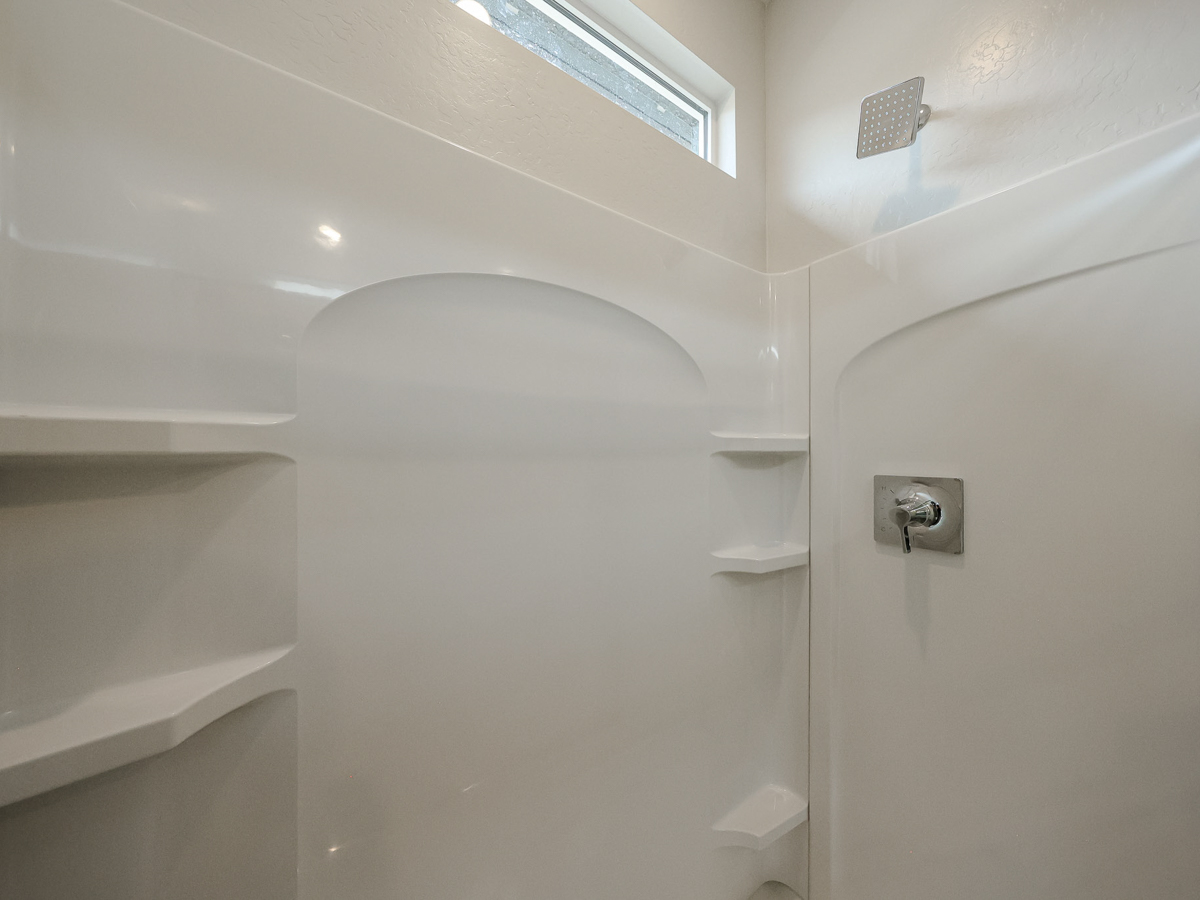 A bathroom with a shower unit.